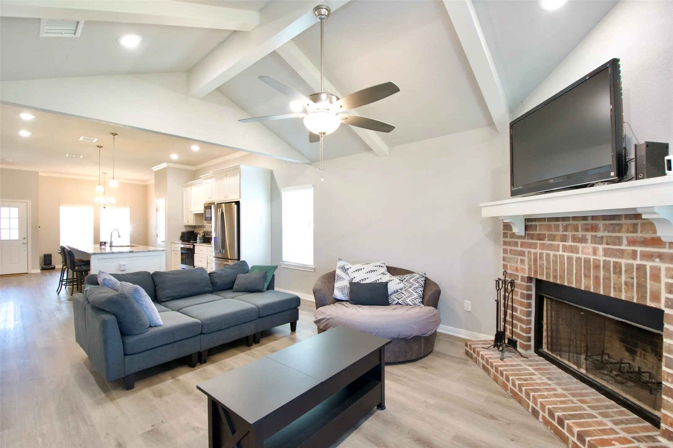 Vaulted ceiling with exposed beams and recessed lighting