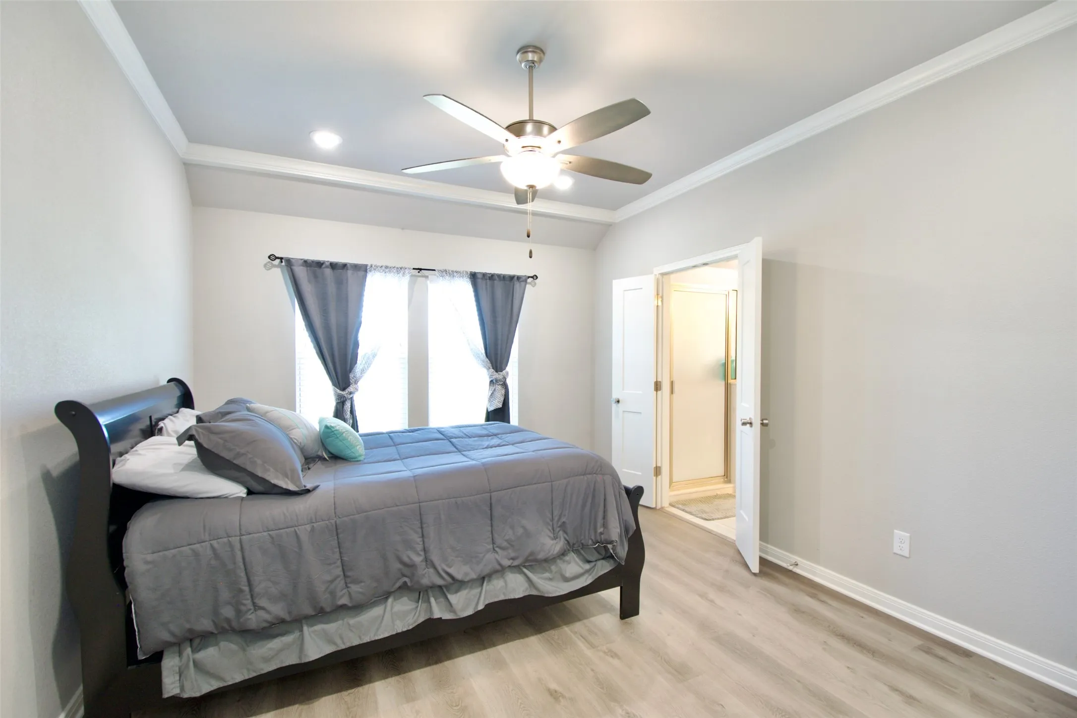 Bedroom featuring light wood-finish flooring and light gray walls