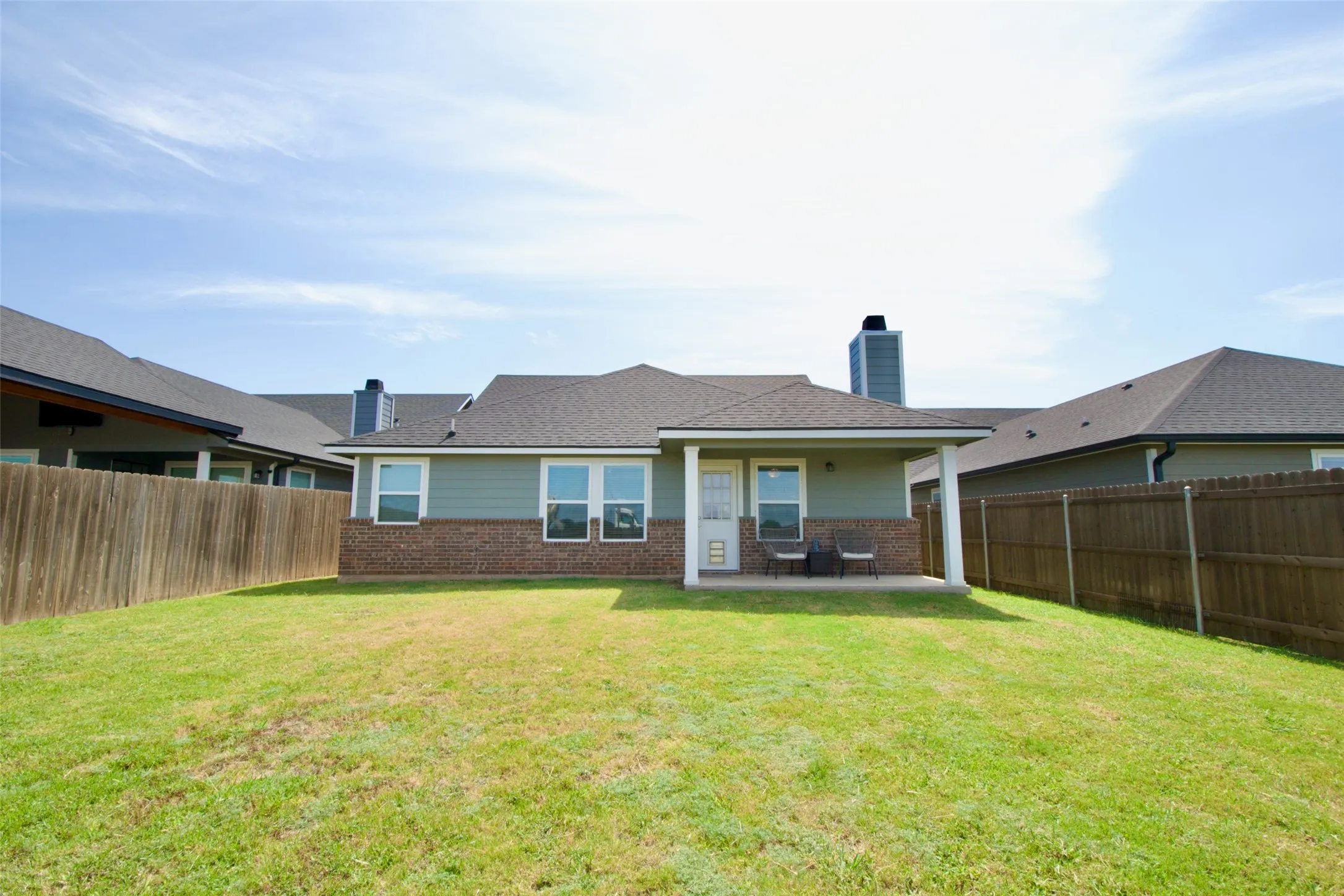 Spacious grassy yard with a privacy fence