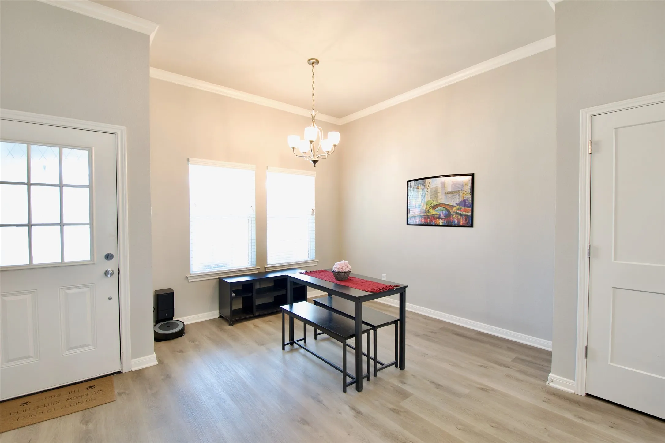 Bright interior space featuring light wood-finish flooring and neutral wall tones