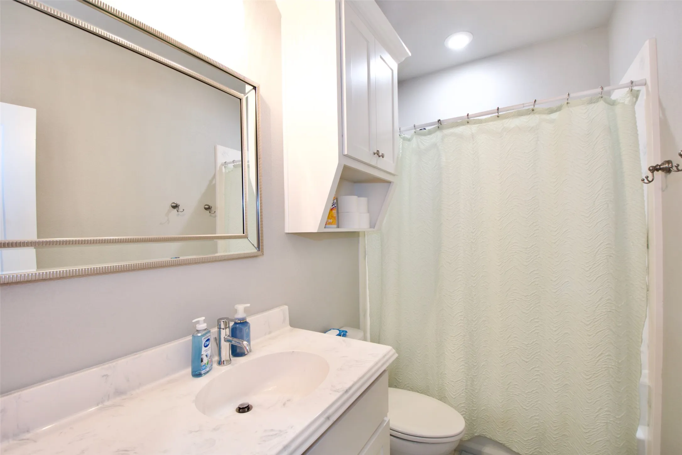 White vanity with an integrated sink and countertop