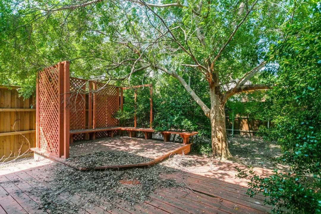 Expansive outdoor deck featuring wood-finish decking and built-in lattice privacy screens