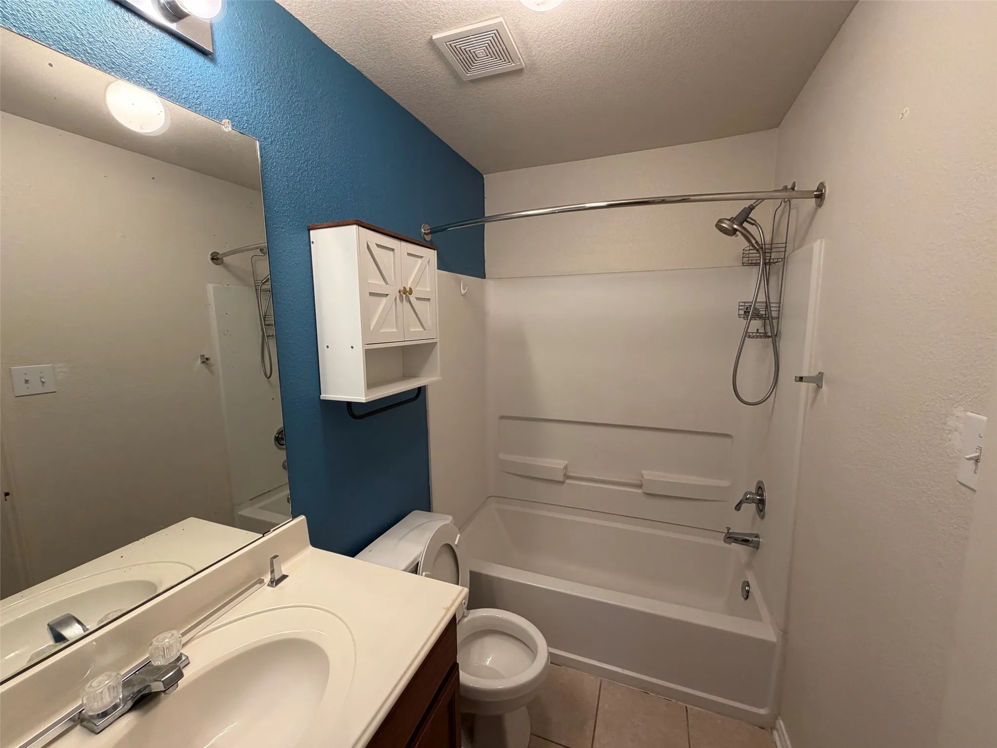 Bathroom featuring a white bathtub and shower combination with a curved shower curtain rod