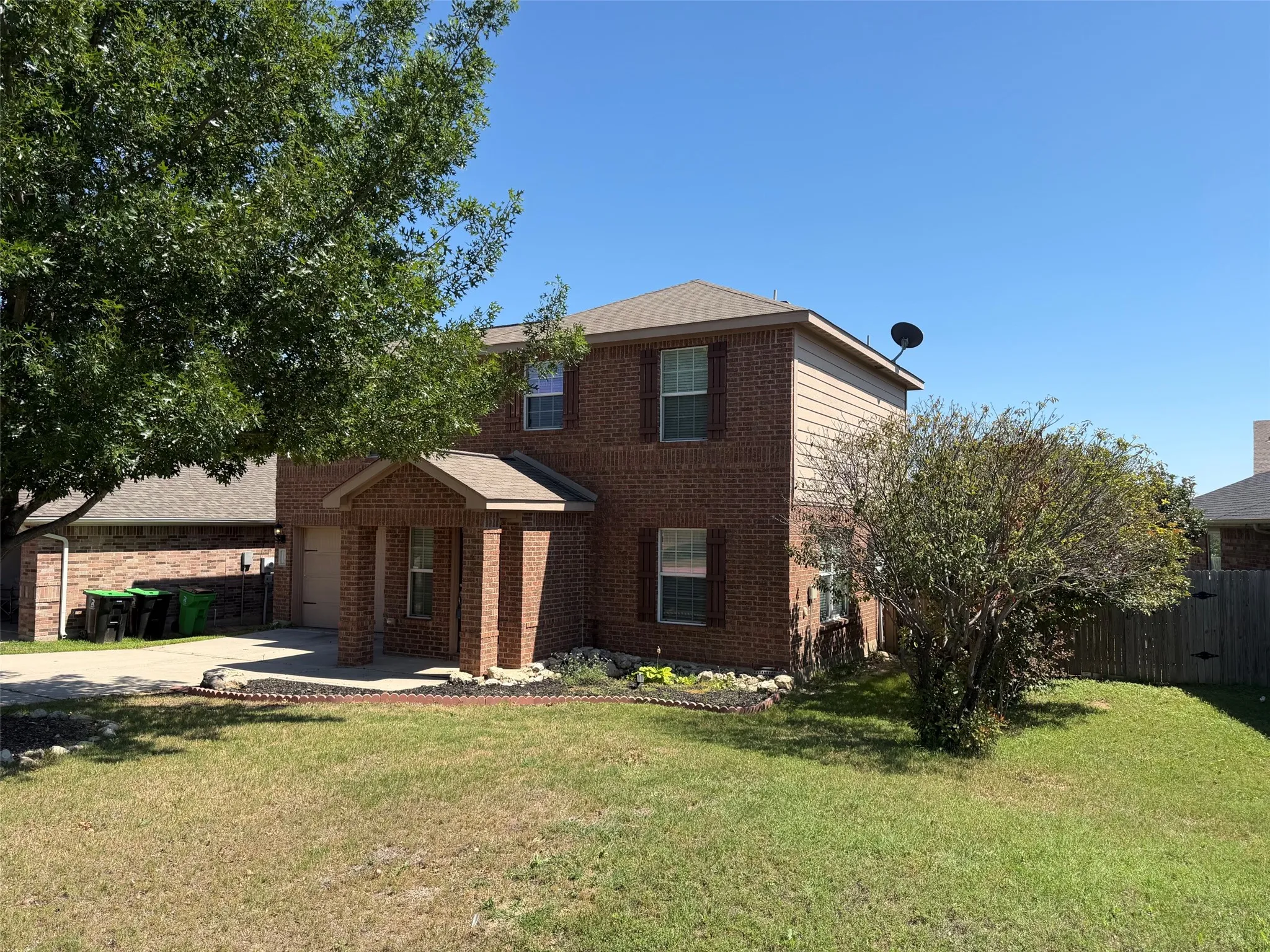 Two-story brick exterior featuring a covered front entry with brick columns