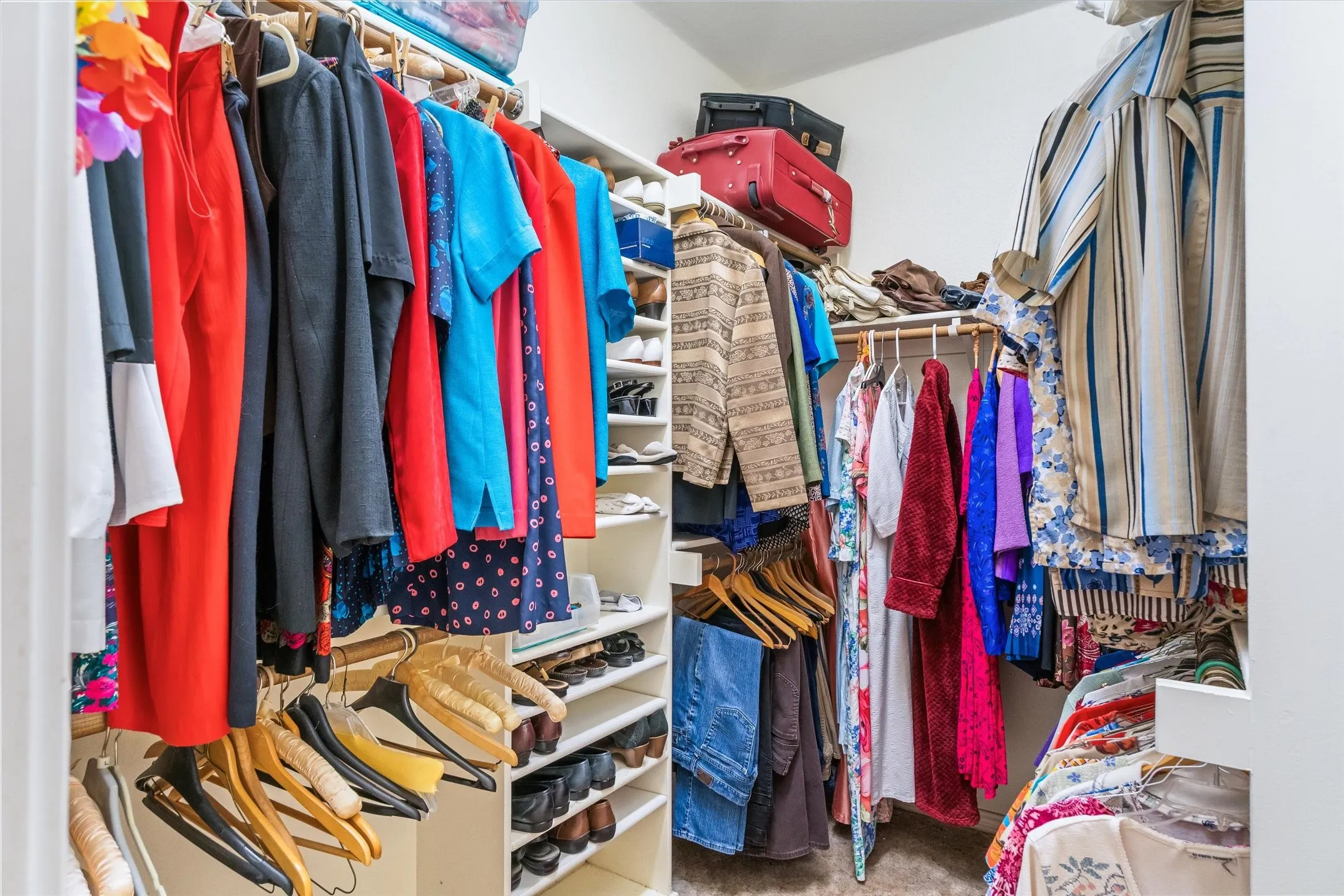 Custom closet system featuring built-in shelving, multiple hanging rods, and integrated shoe storage