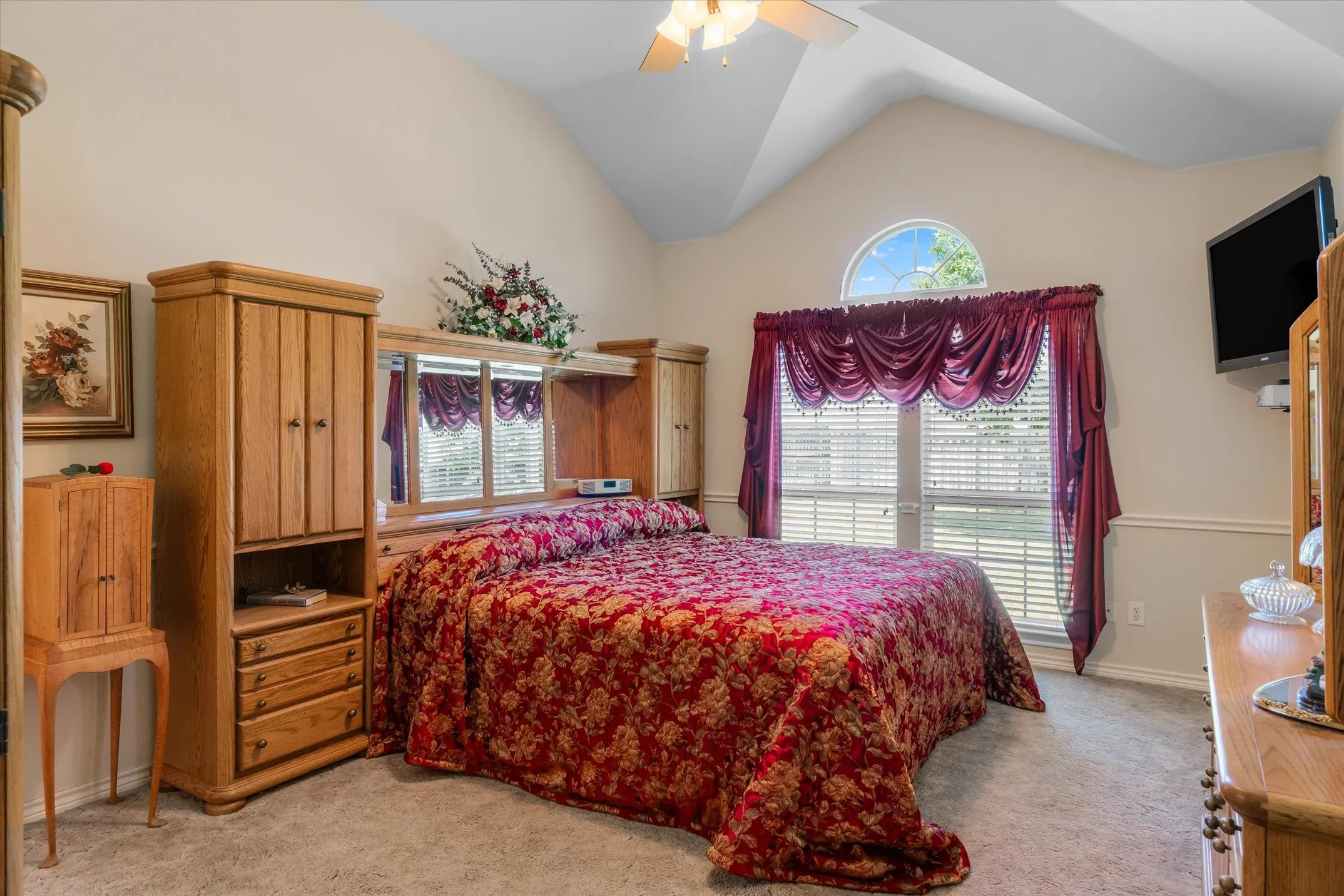 Bedroom featuring vaulted ceilings and neutral-toned carpeting