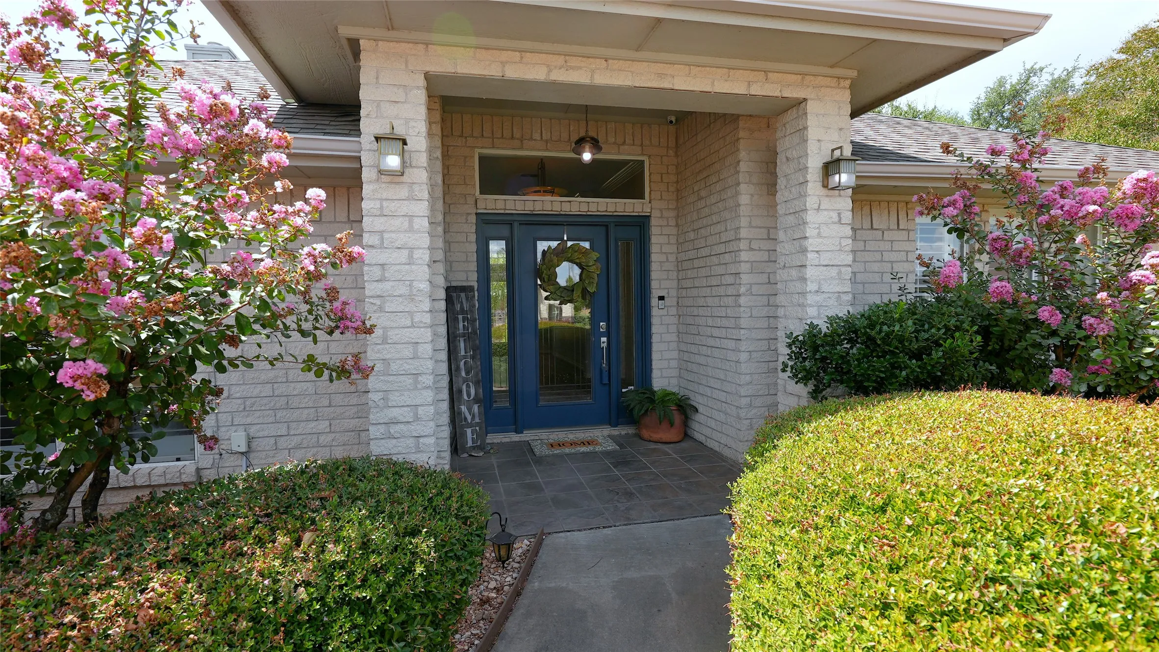 5614 Wedgefield-3 bedroom 3 full bath 2,040 SF. Single-story residence featuring a gray shingle roof, light-colored brick exterior, and a circle driveway
