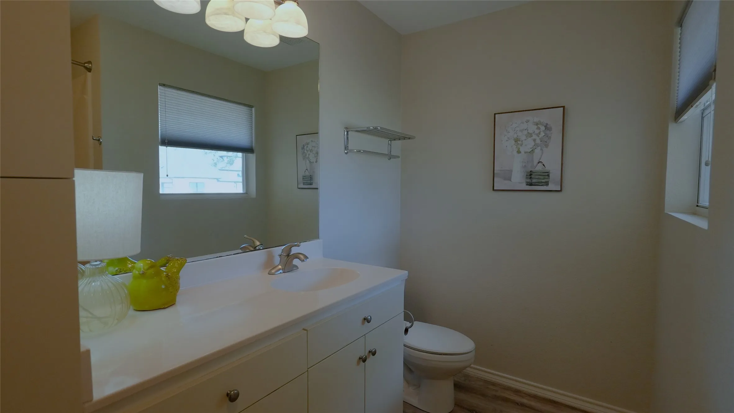 Vanity with integrated sink, chrome fixtures, and white cabinetry