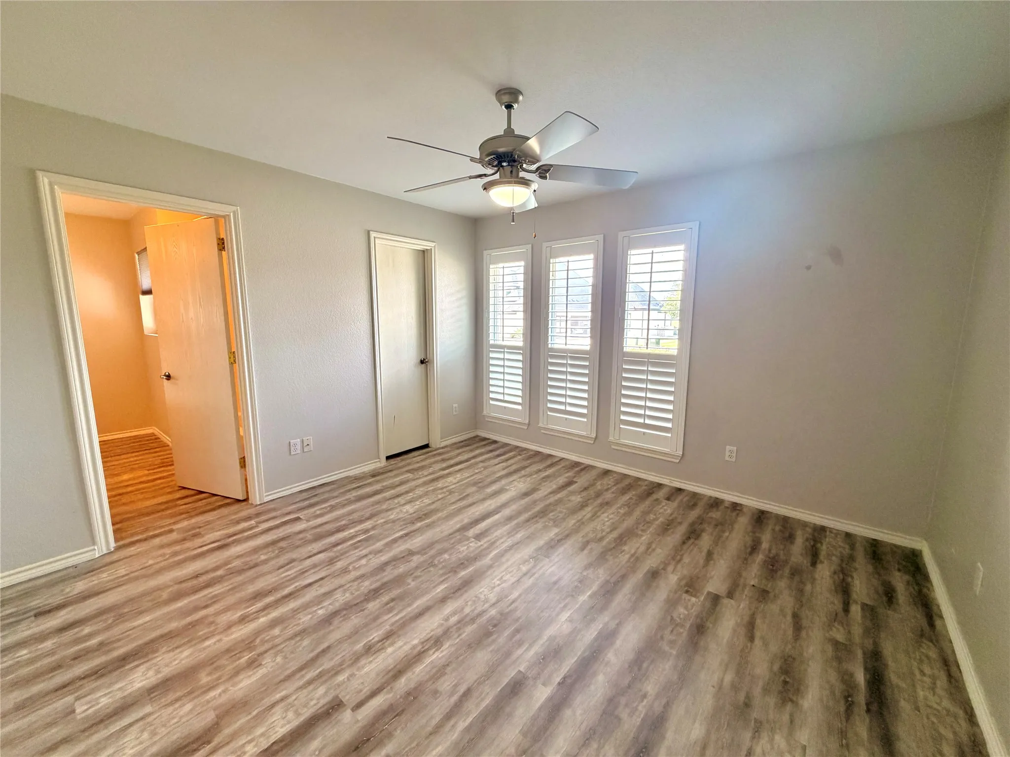 Bedroom 2- could be 2nd primary bedroom-has its oown bathroom Spacious room featuring wood-finish flooring, light gray walls, and white trim