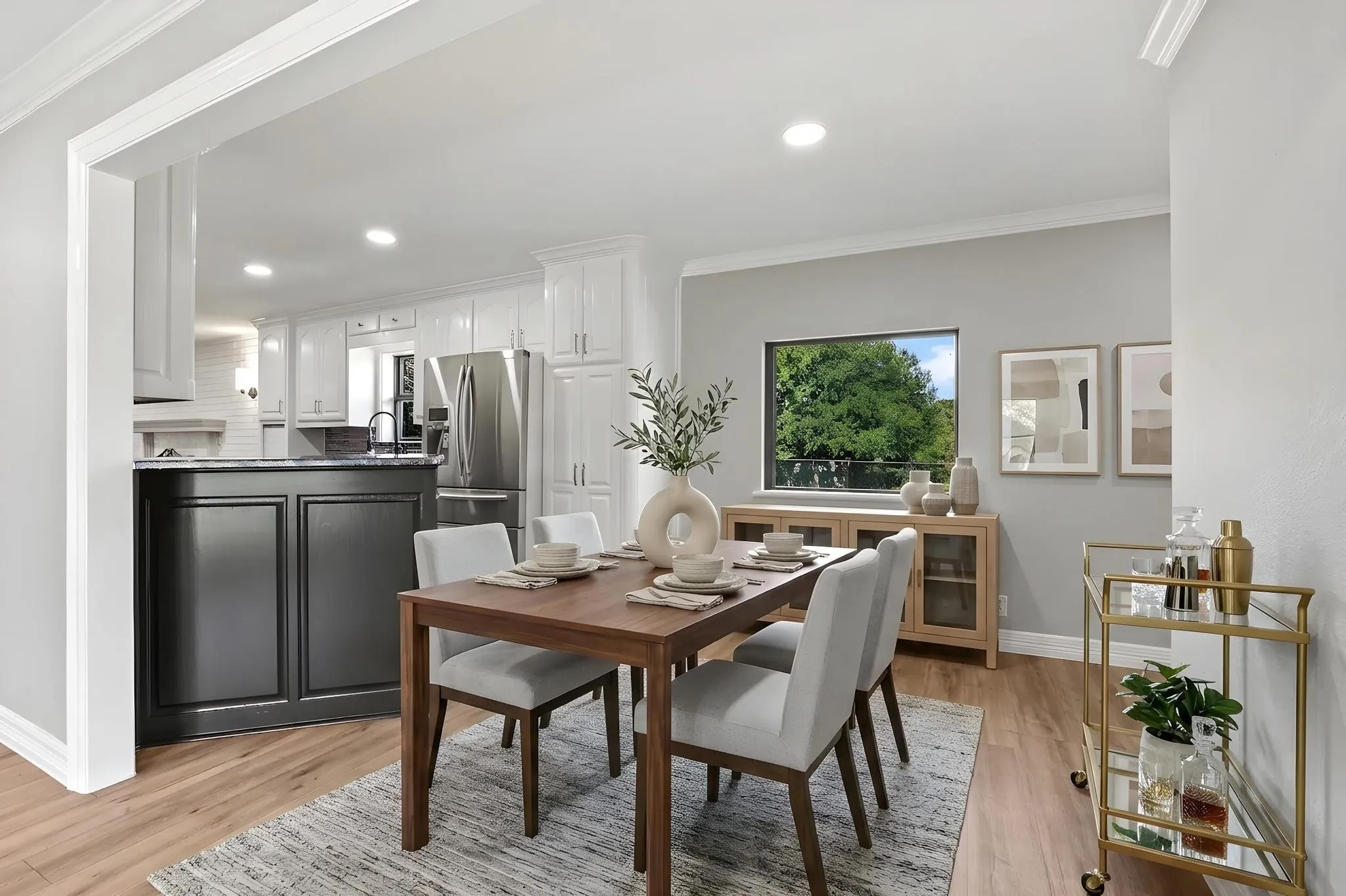 Dining area featuring wood-finish flooring, a broad window, and crown molding