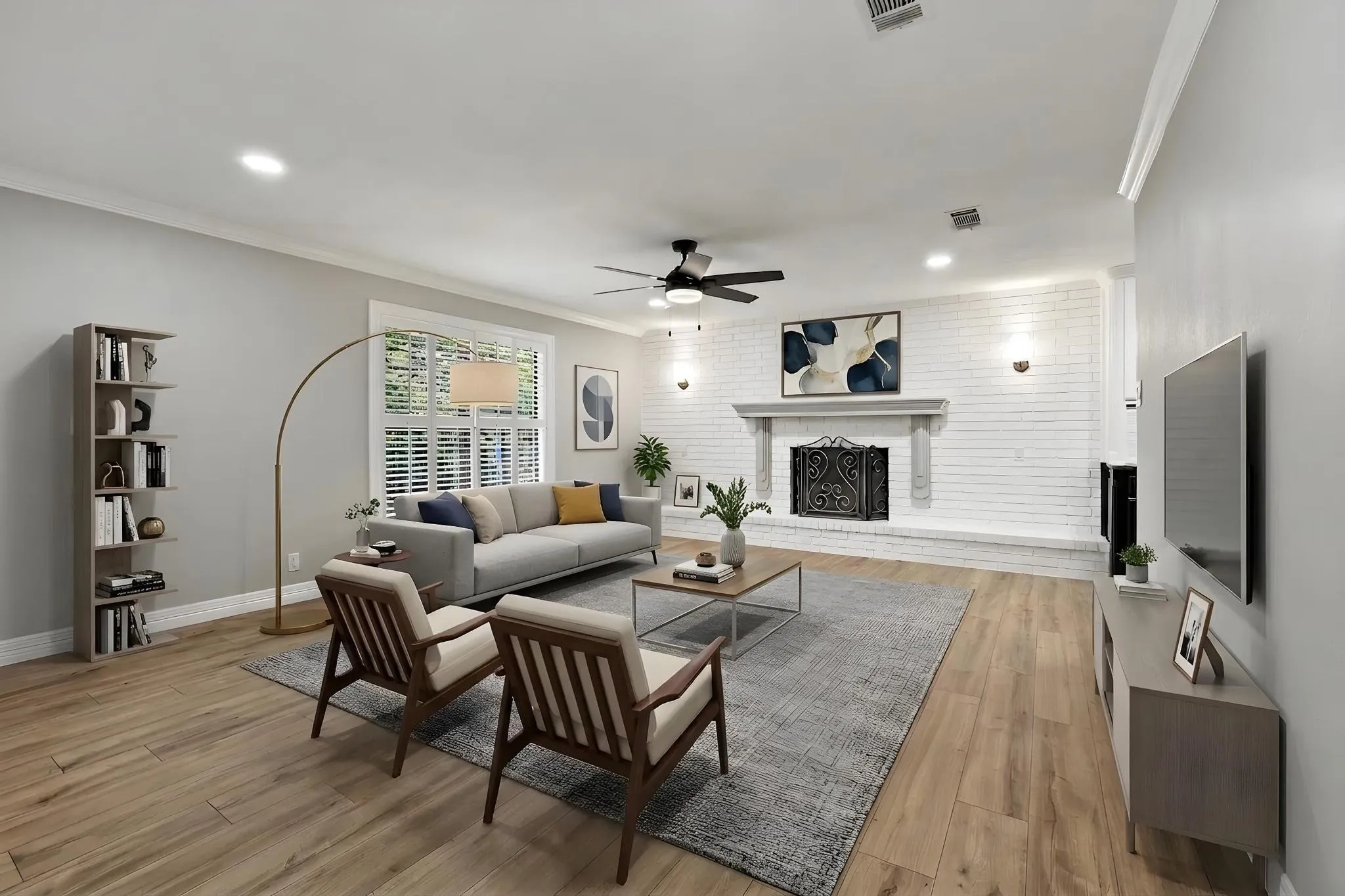Living area featuring wood-finish flooring, a white brick fireplace with a detailed screen, crown molding, and recessed lighting