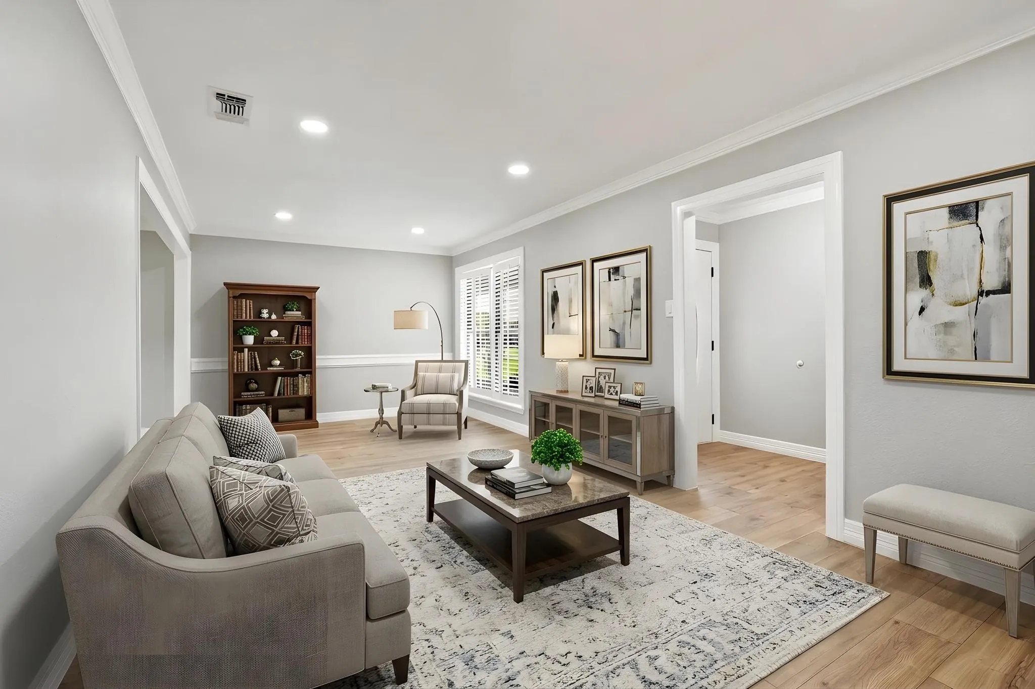 Spacious living area featuring light wood-finish flooring, recessed lighting, and white crown molding