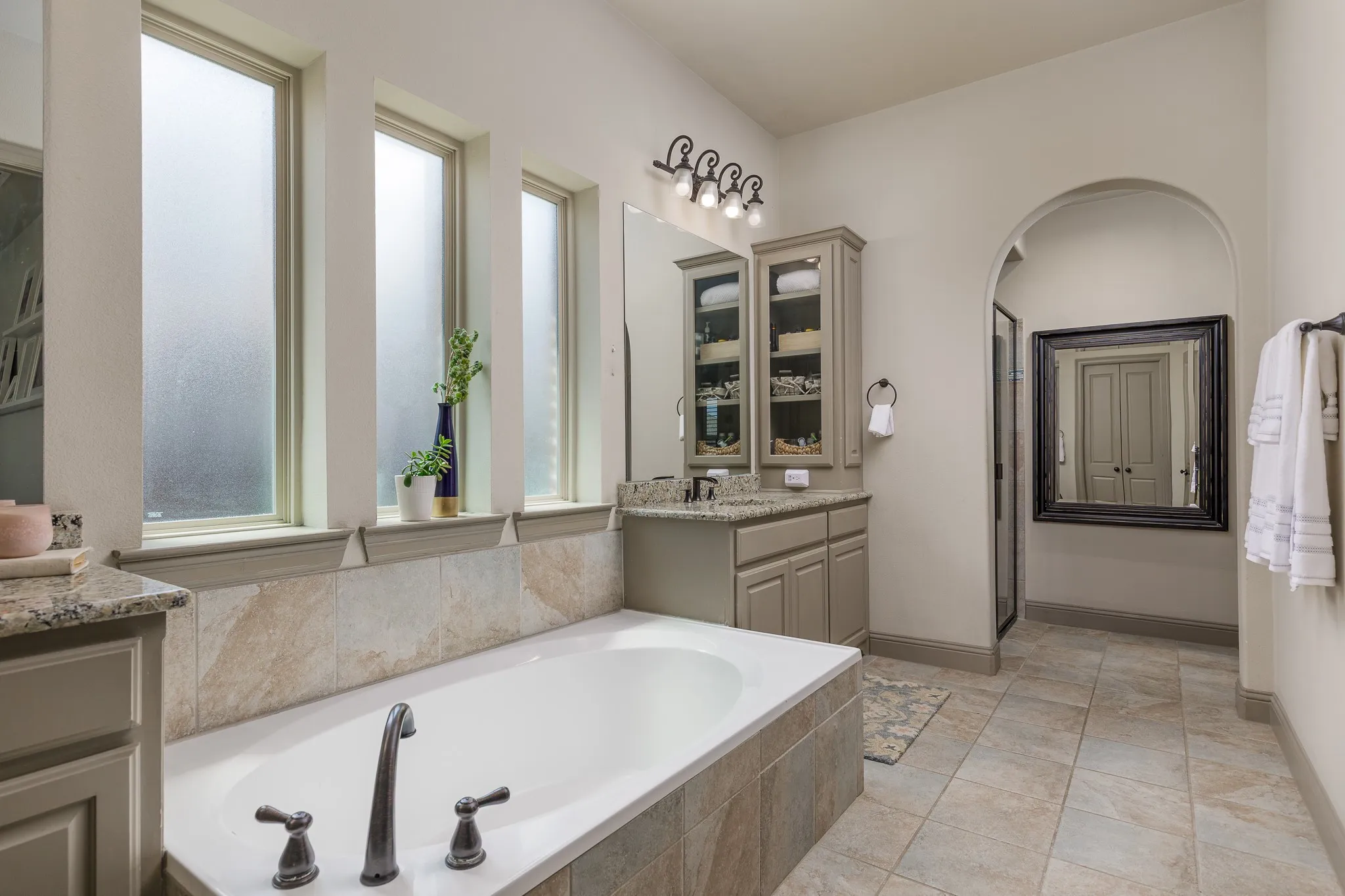 Primary bathroom features a garden tub, separate shower, dual vanities, and dual closets.