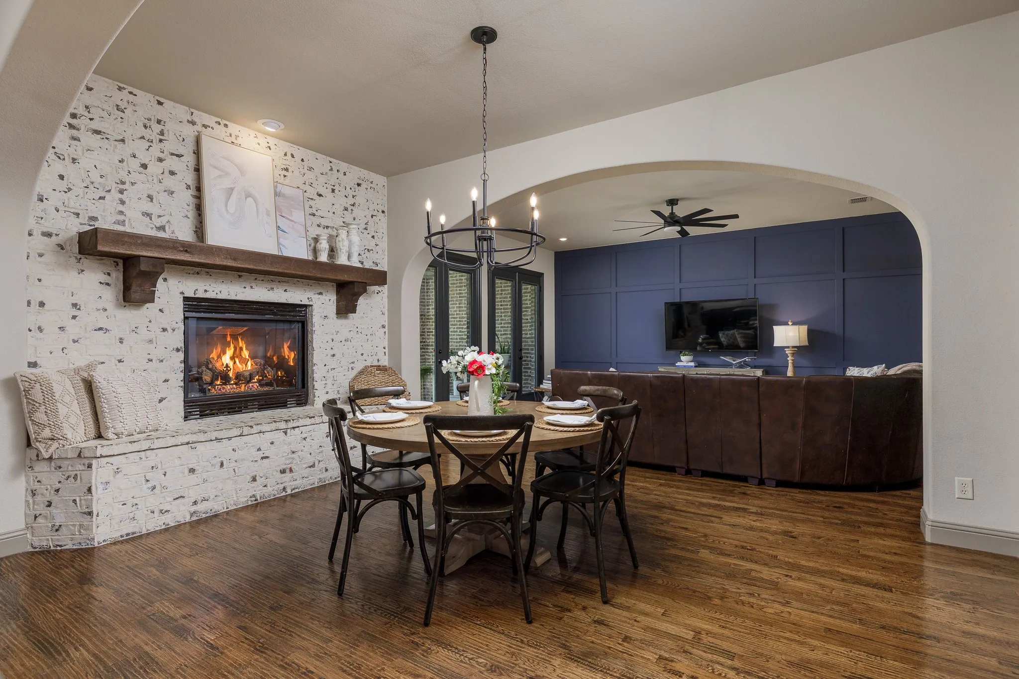 Spacious dining area with fireplace is thoughtfully positioned between the kitchen and living area for an open layout.