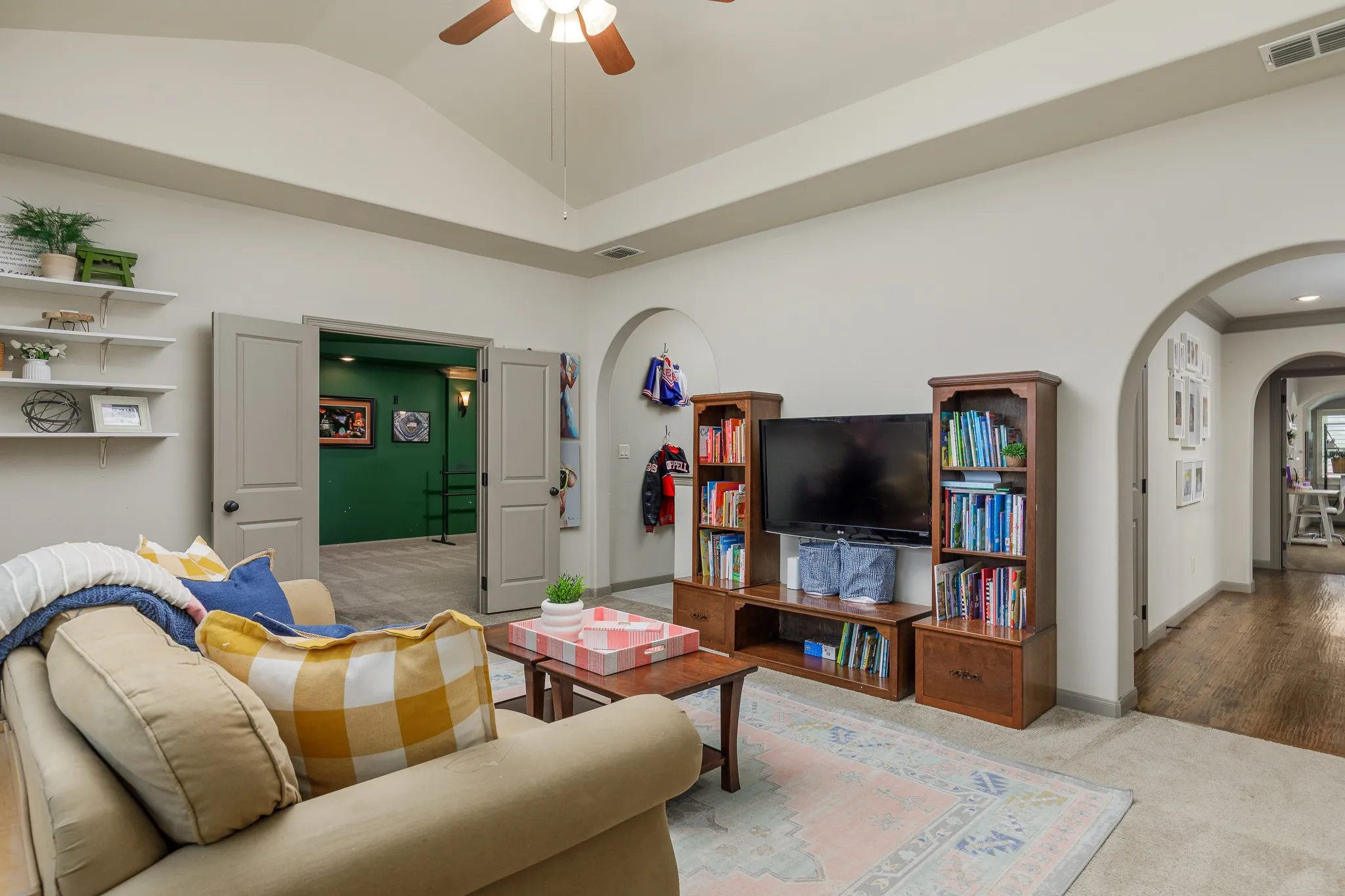 The game room provides access to the media room and wet bar area.