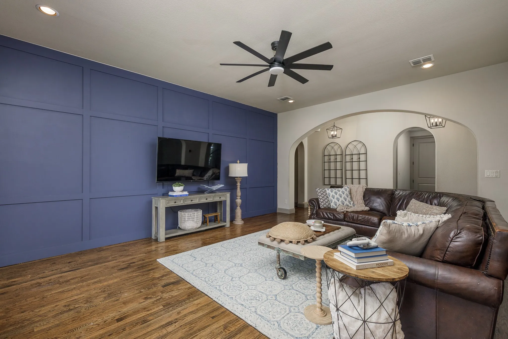 Living area featuring a wood paneled accent wall.