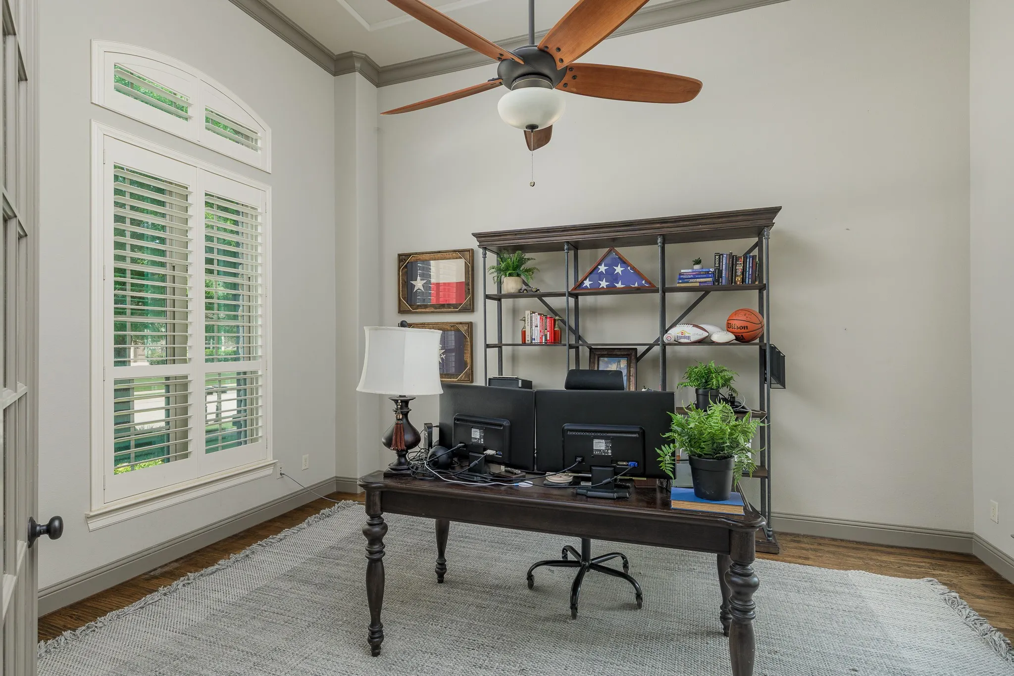The office features french doors and has views of the front yard and backyard with windows on 2 sides of the room.