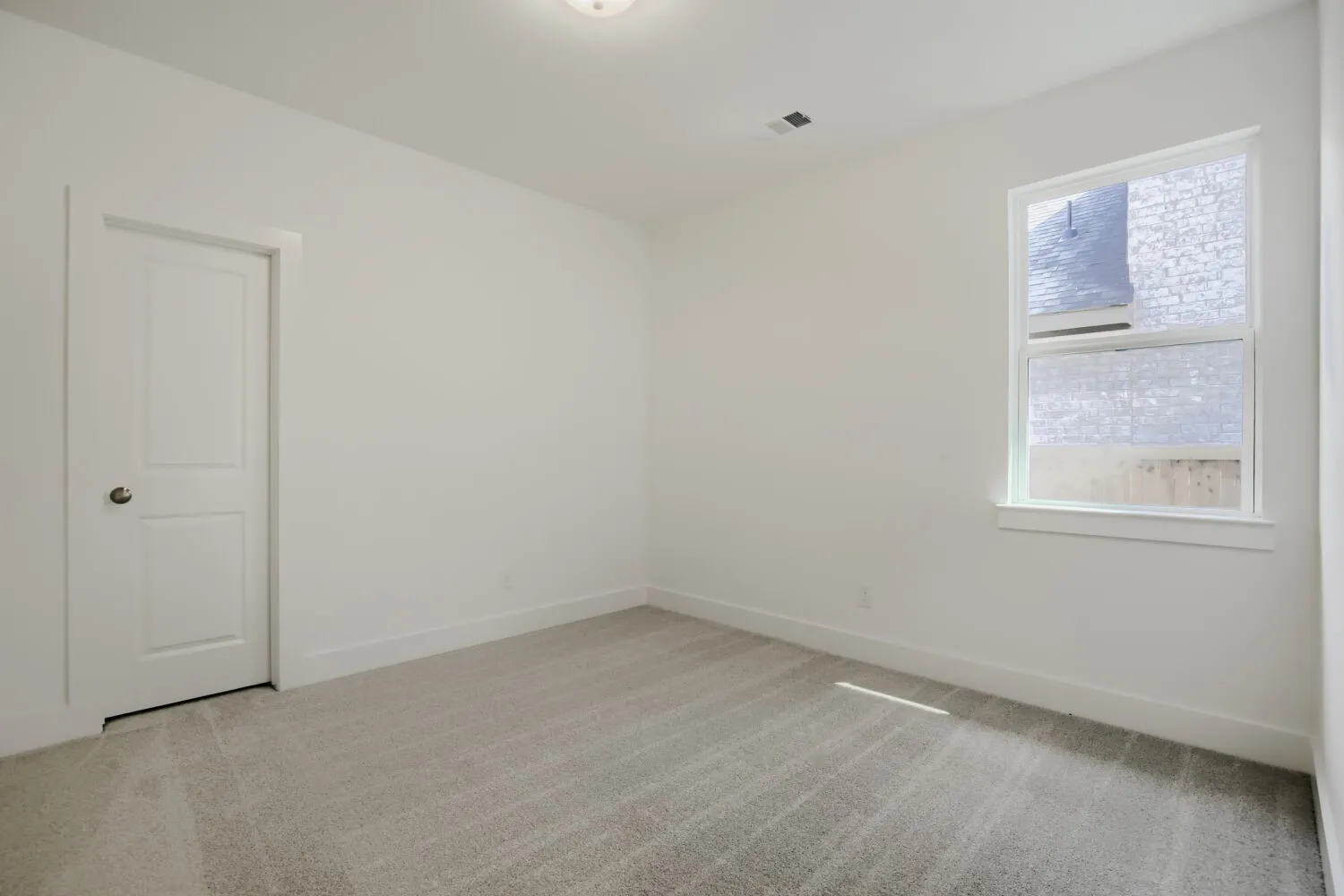 Neutral carpet flooring complemented by white walls and trim