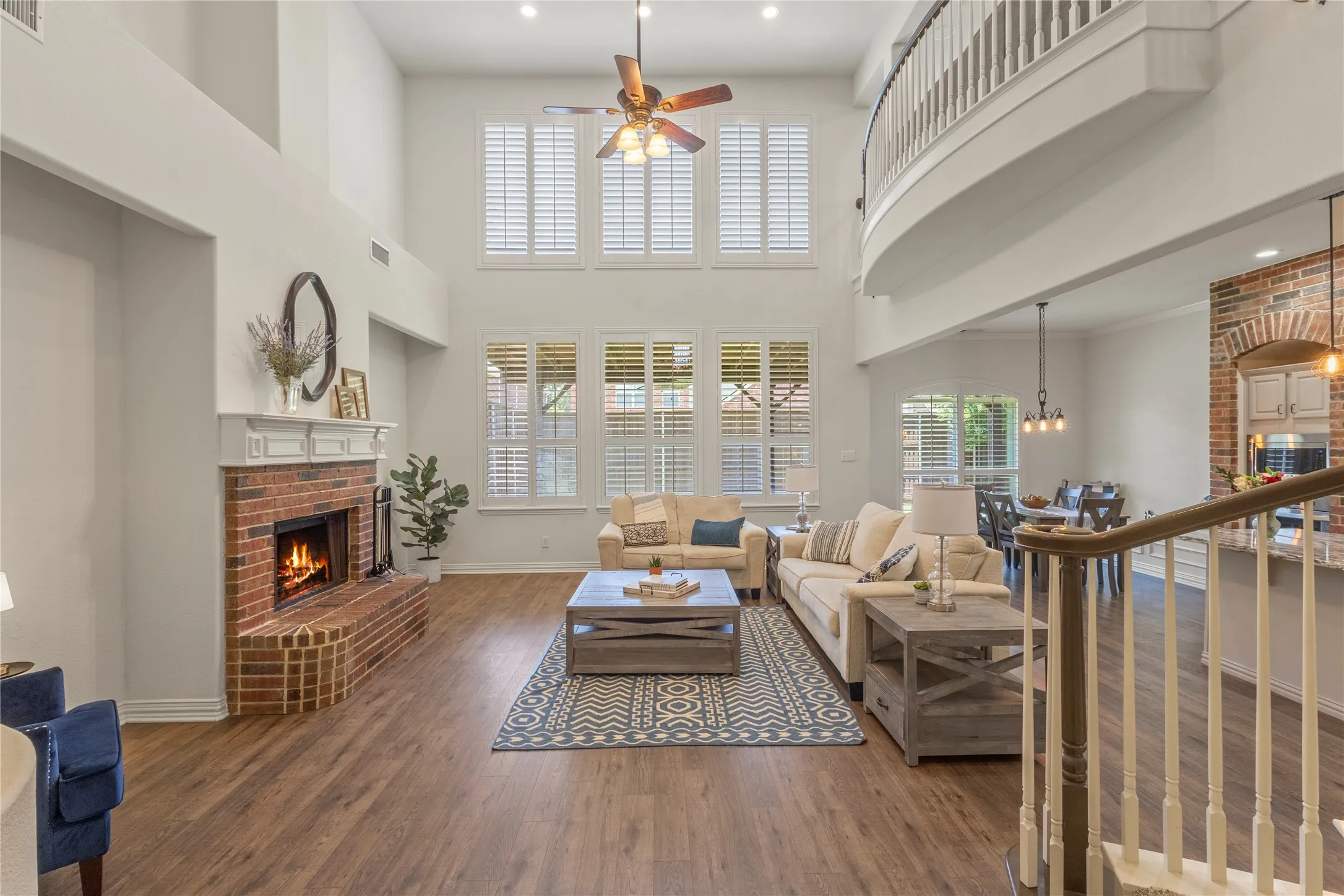 Soaring ceilings, LVP, plantation shutters, wood burning fireplace