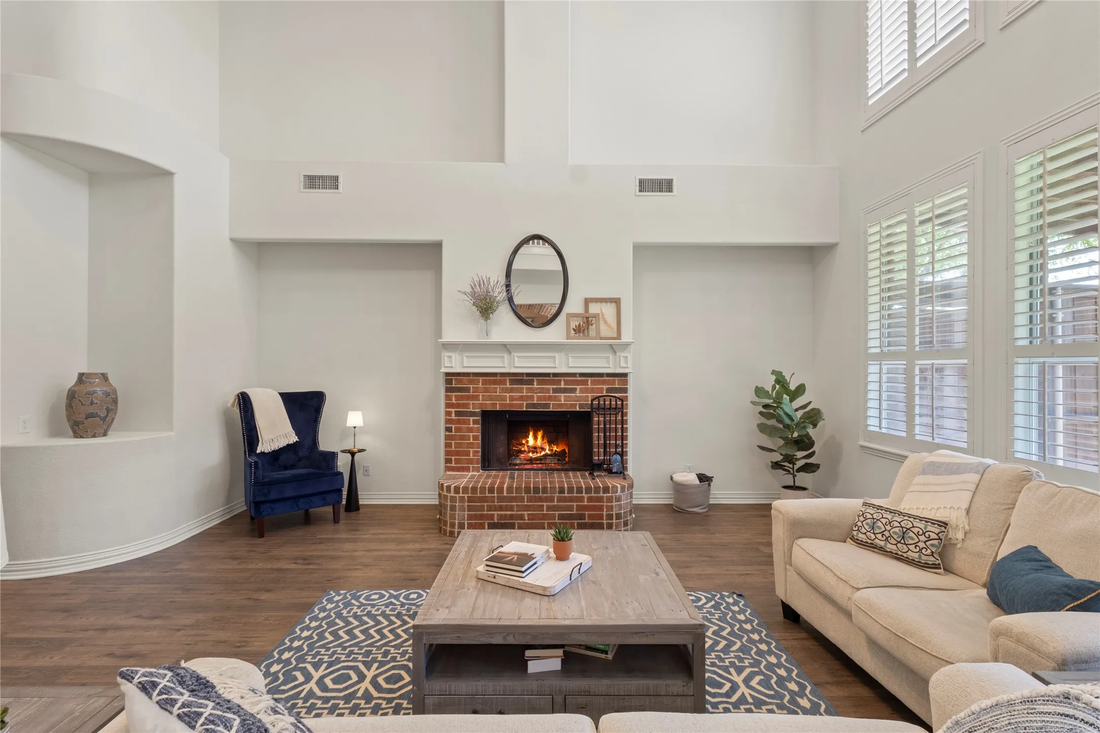 Soaring ceilings, wood burning fireplace, plantation shutters