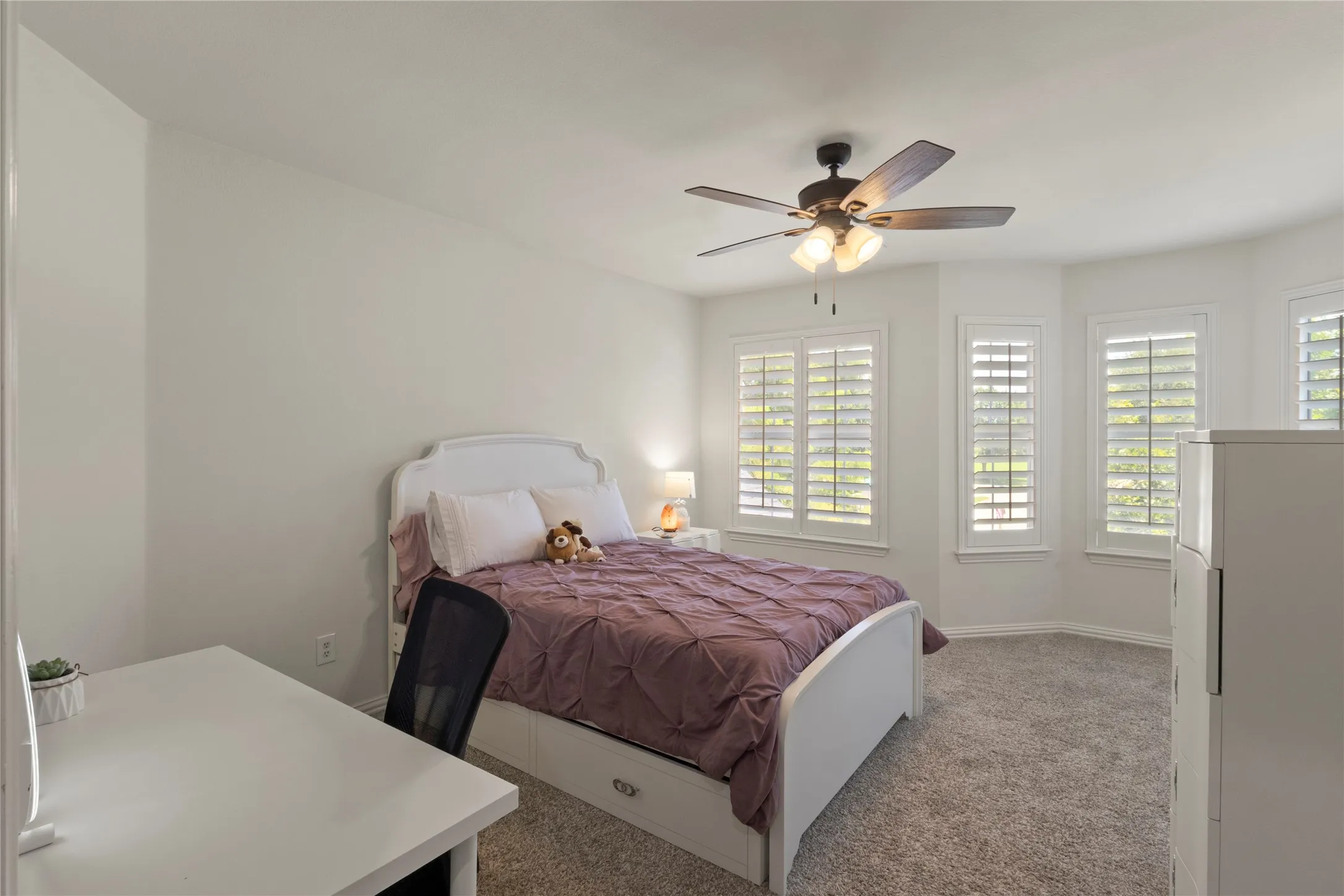 Upstairs secondary bedroom with octagonal wall and plantation shutters