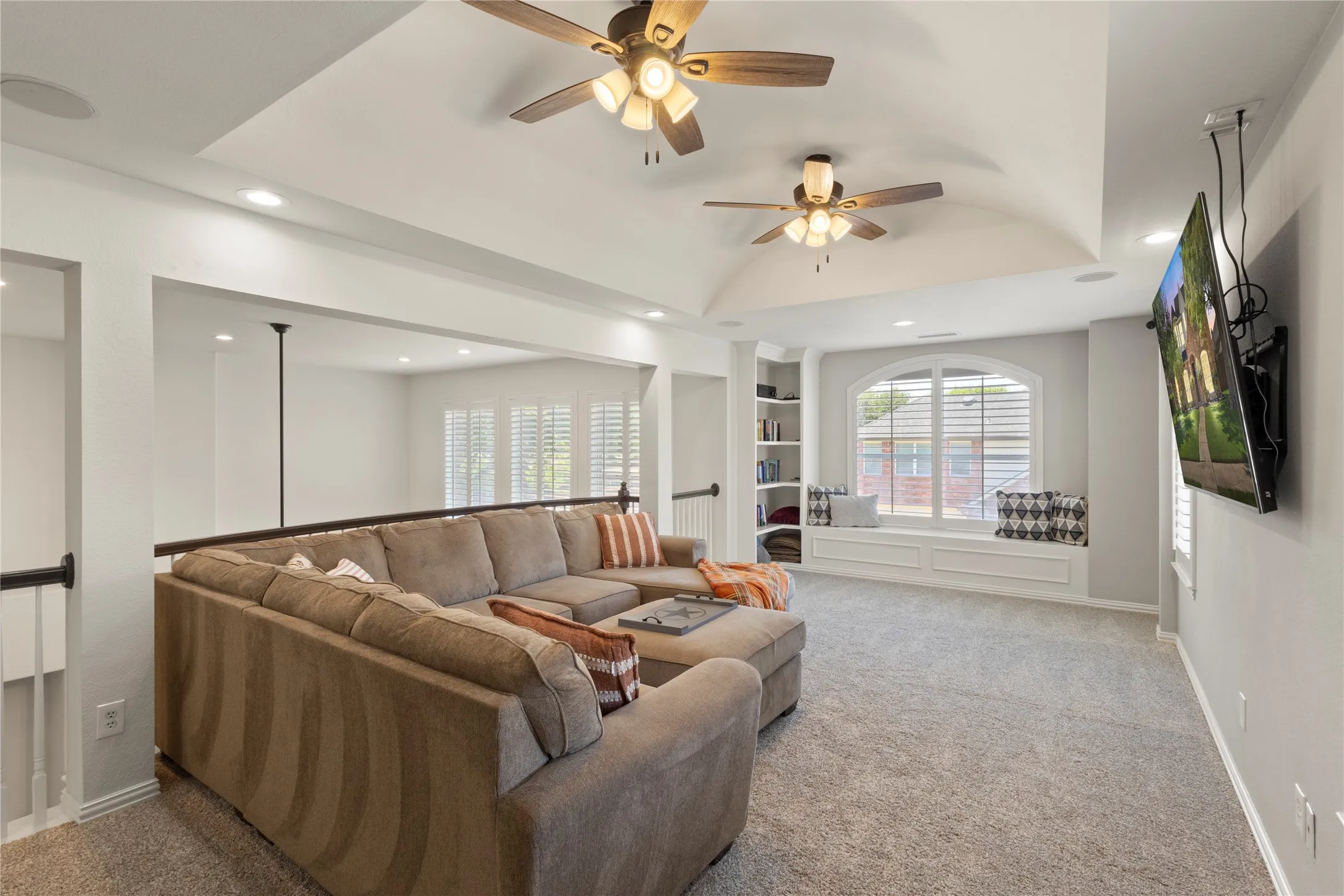 Upstairs game room with built in window seat an shelving