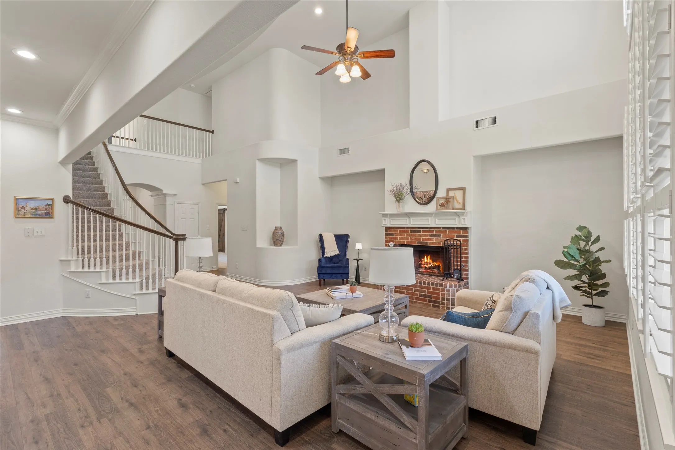 Open concept living, plantation shutters, wood burning fireplace