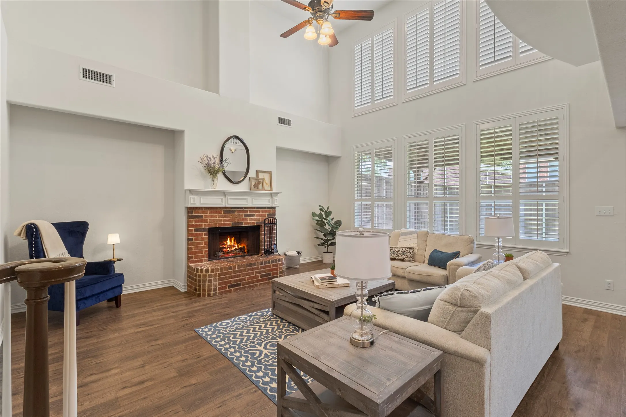 Soaring ceilings, LVP, plantation shutters, wood burning fireplace