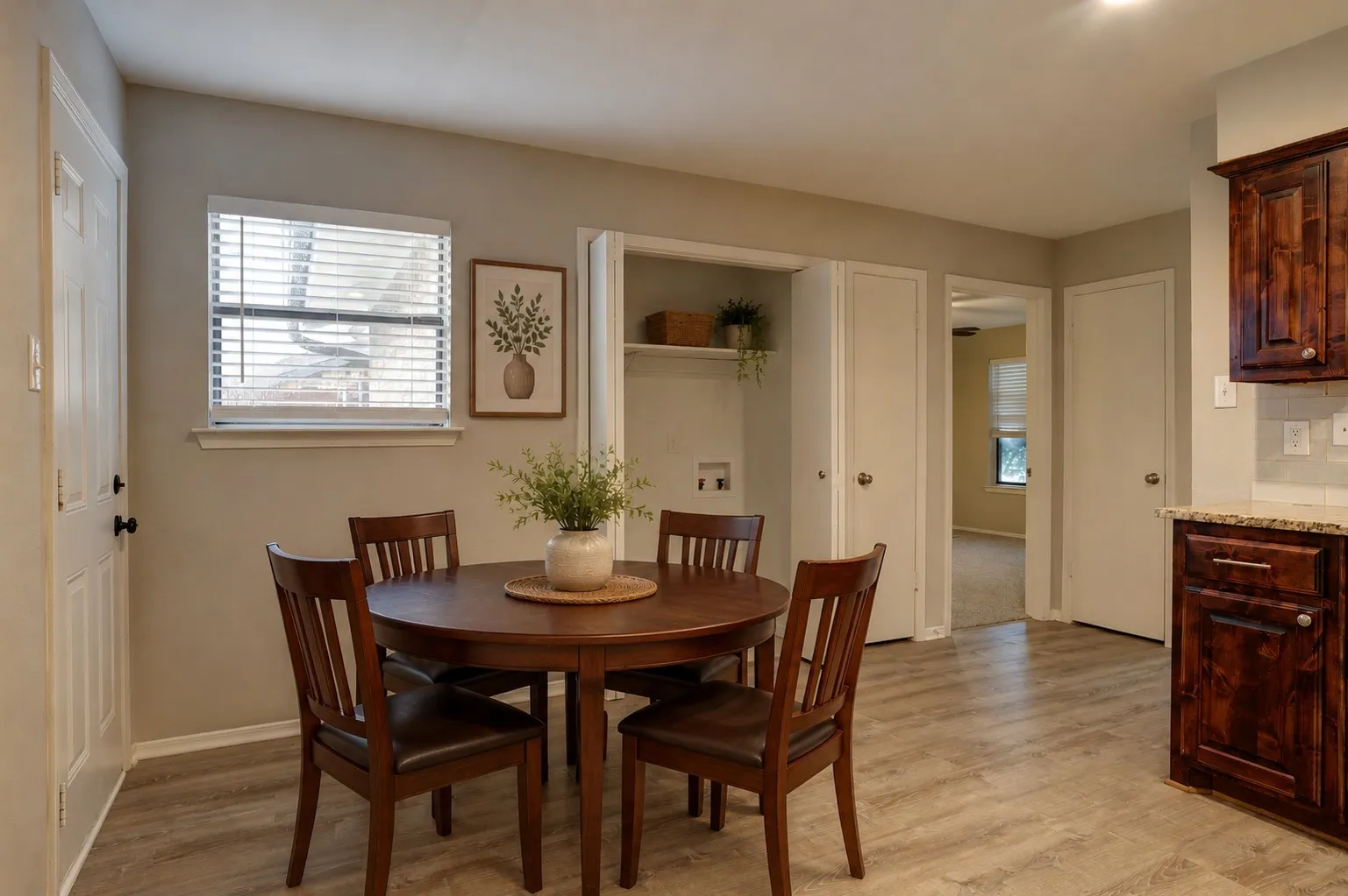 Virtually Staged. Dining area featuring wood-finish flooring, a window with blinds, and neutral wall tones