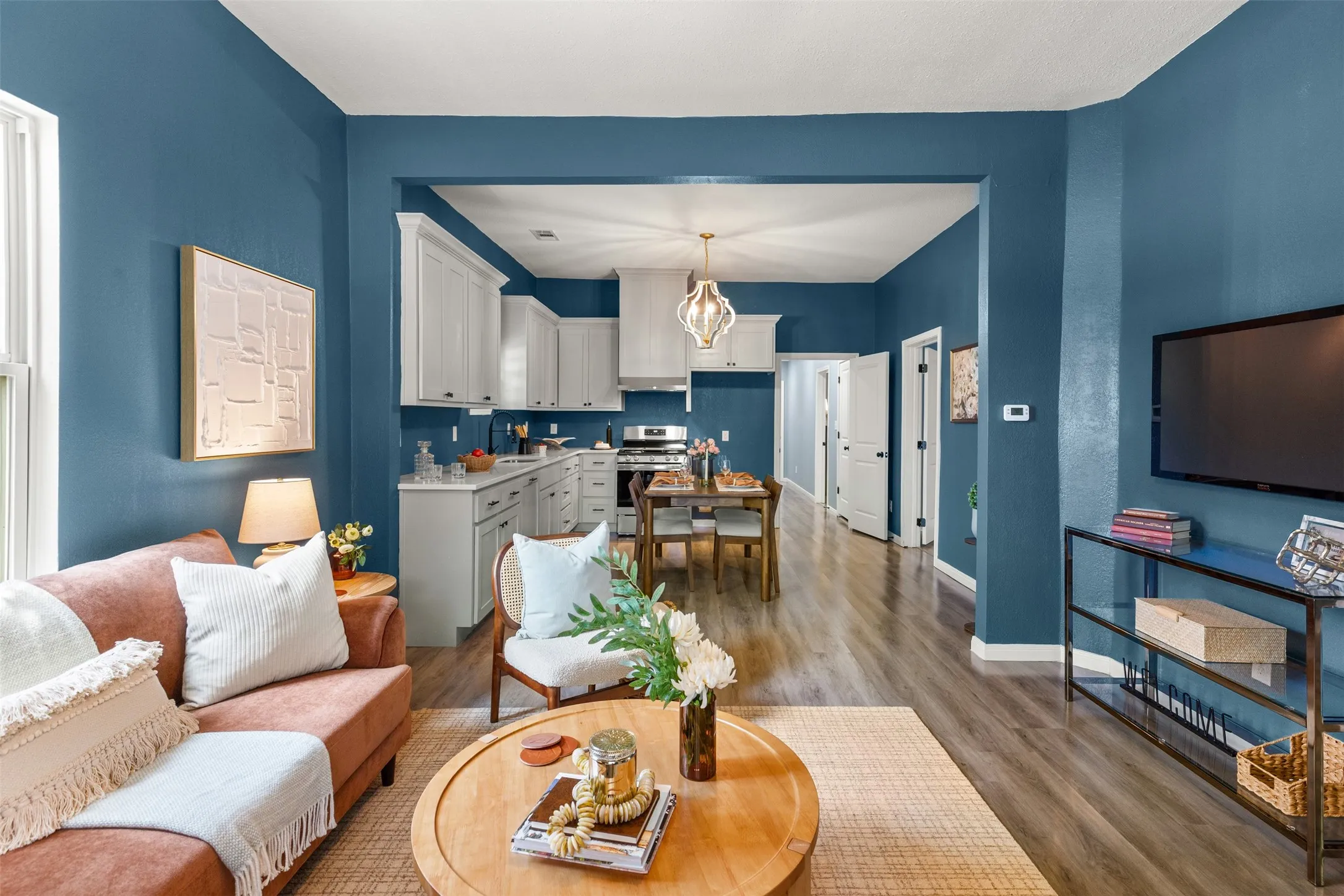 Open-concept living area with wood-finish flooring