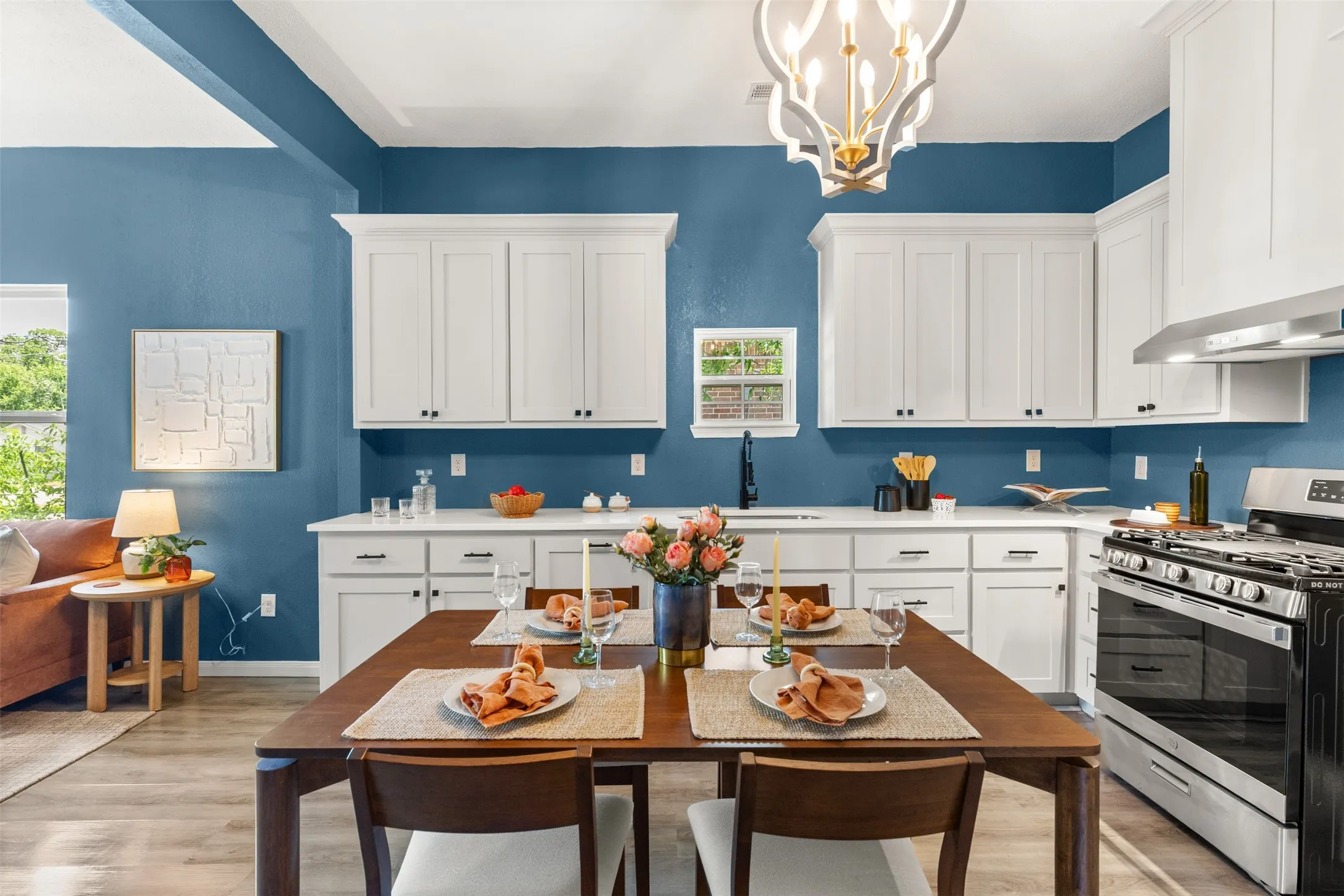 Modern kitchen with white cabinetry and contrasting blue walls