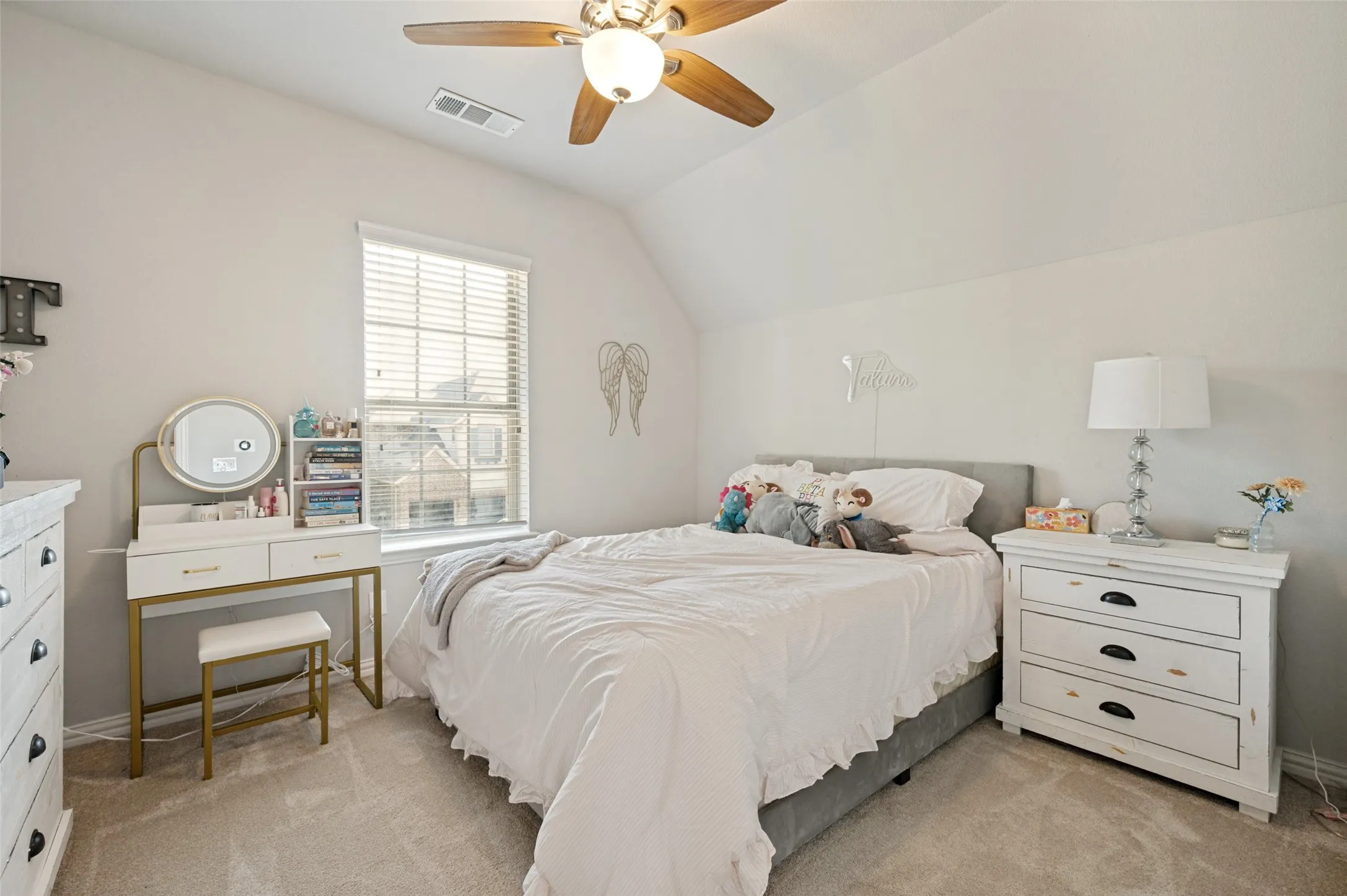 Carpeted room featuring a sloped ceiling, ceiling fan with integrated lighting, window with blinds, and light gray wall paint