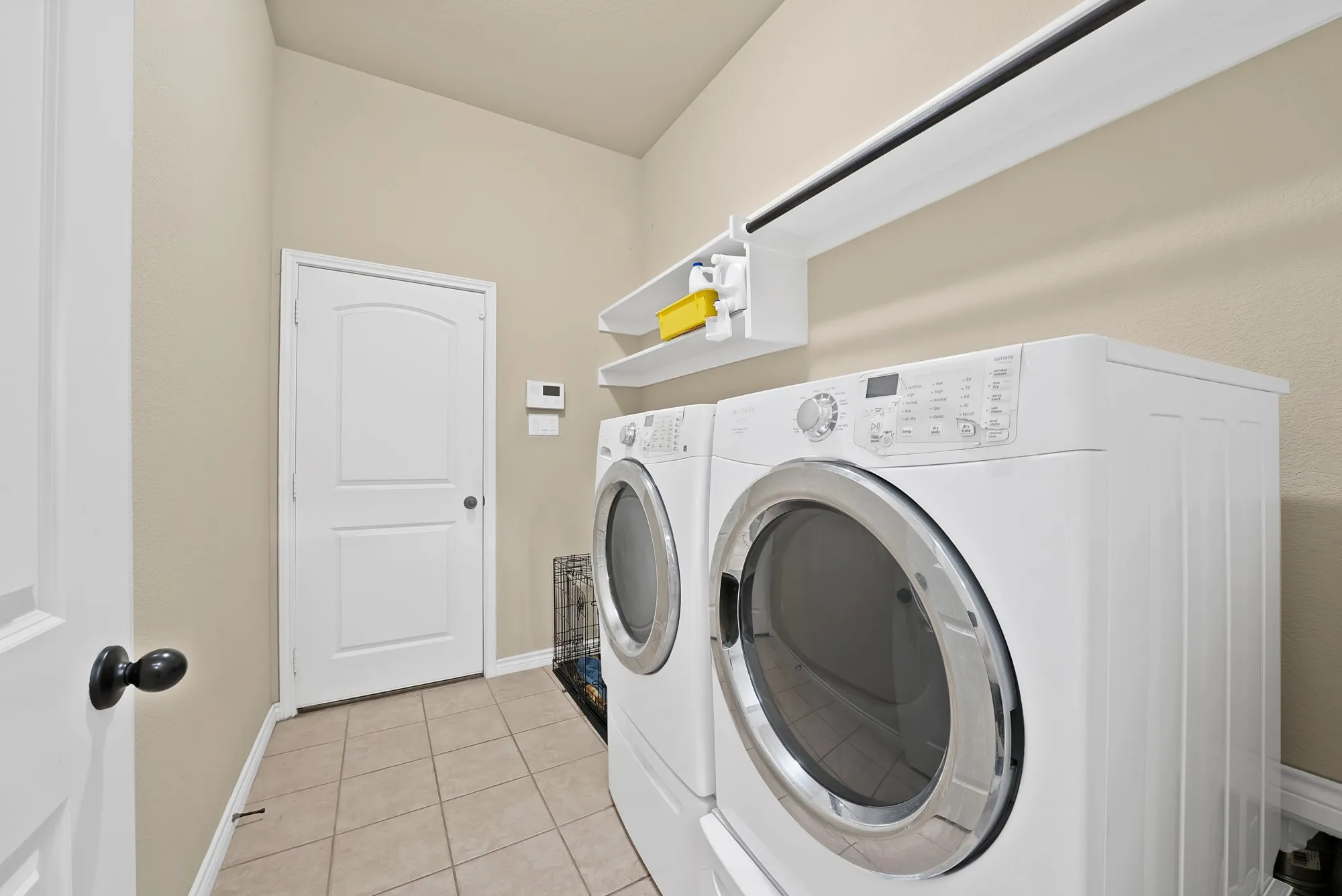 Large utility room with door to garage and has room for additional storage