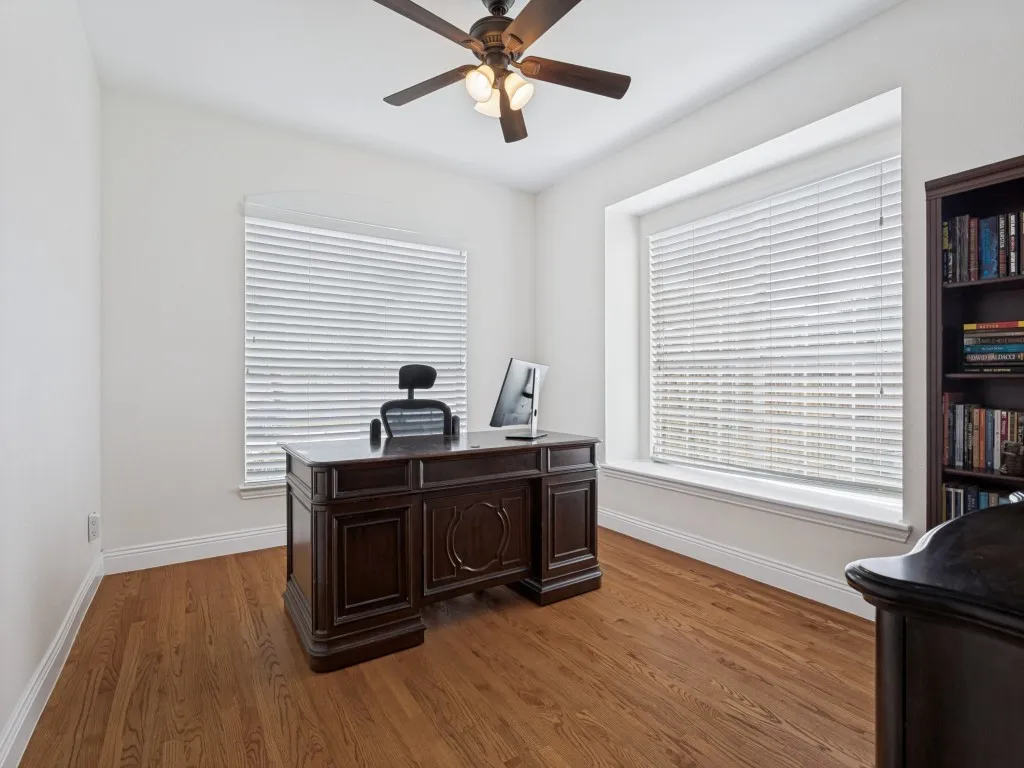 Spacious room featuring wood flooring and ample natural light from a large window