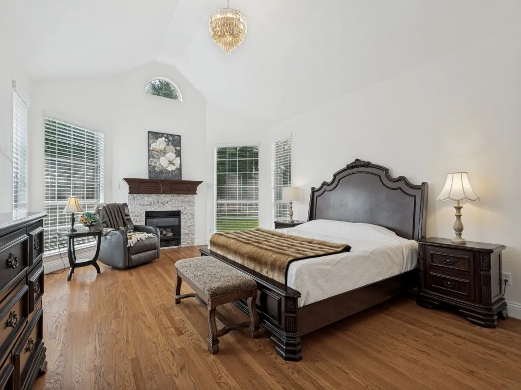 Spacious room with vaulted ceilings and wood-finish flooring