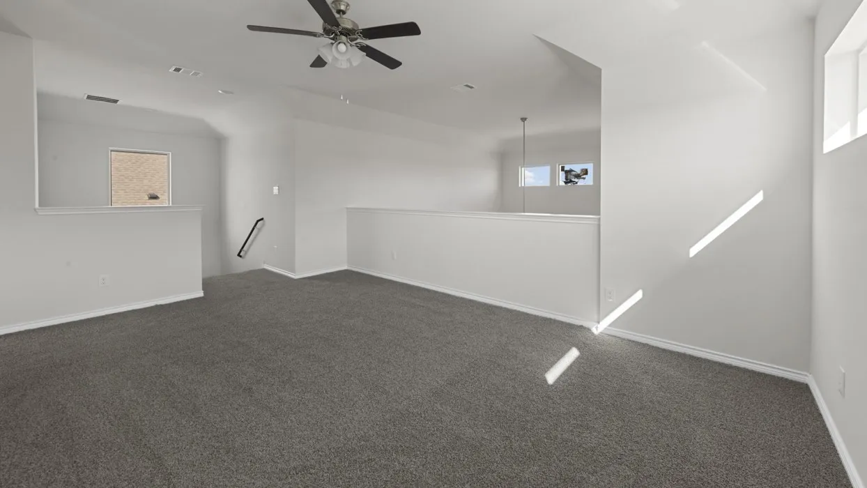 Spacious loft area featuring neutral gray carpet and light-colored walls