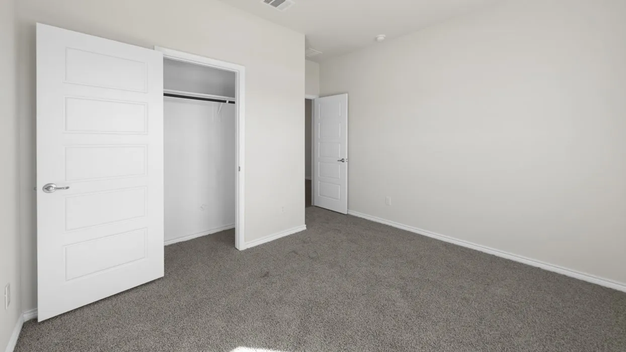 Room featuring light gray carpet, white painted walls, and a white interior door with contemporary paneling