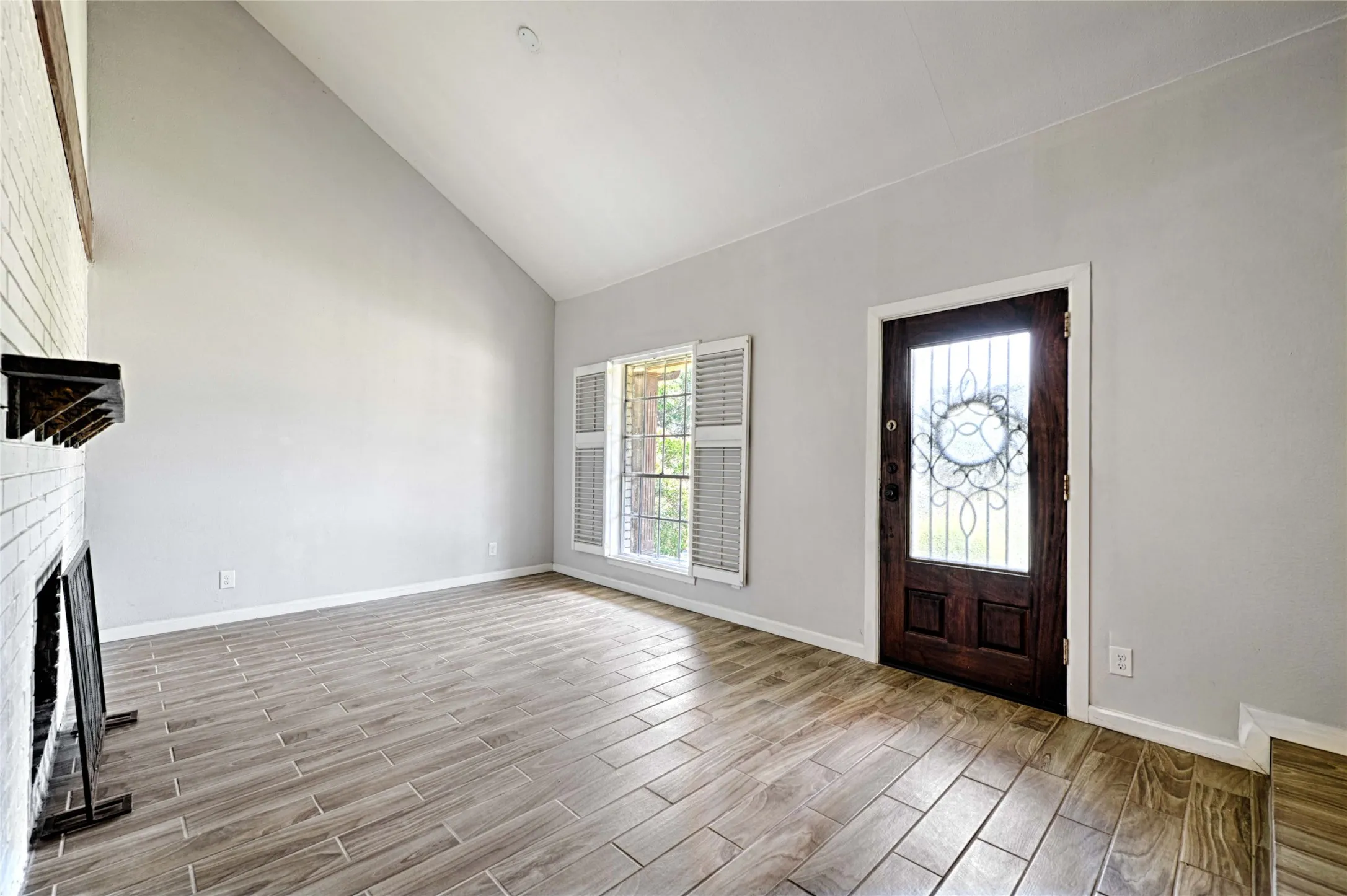 Vaulted ceilings complement the wood-finish tile flooring