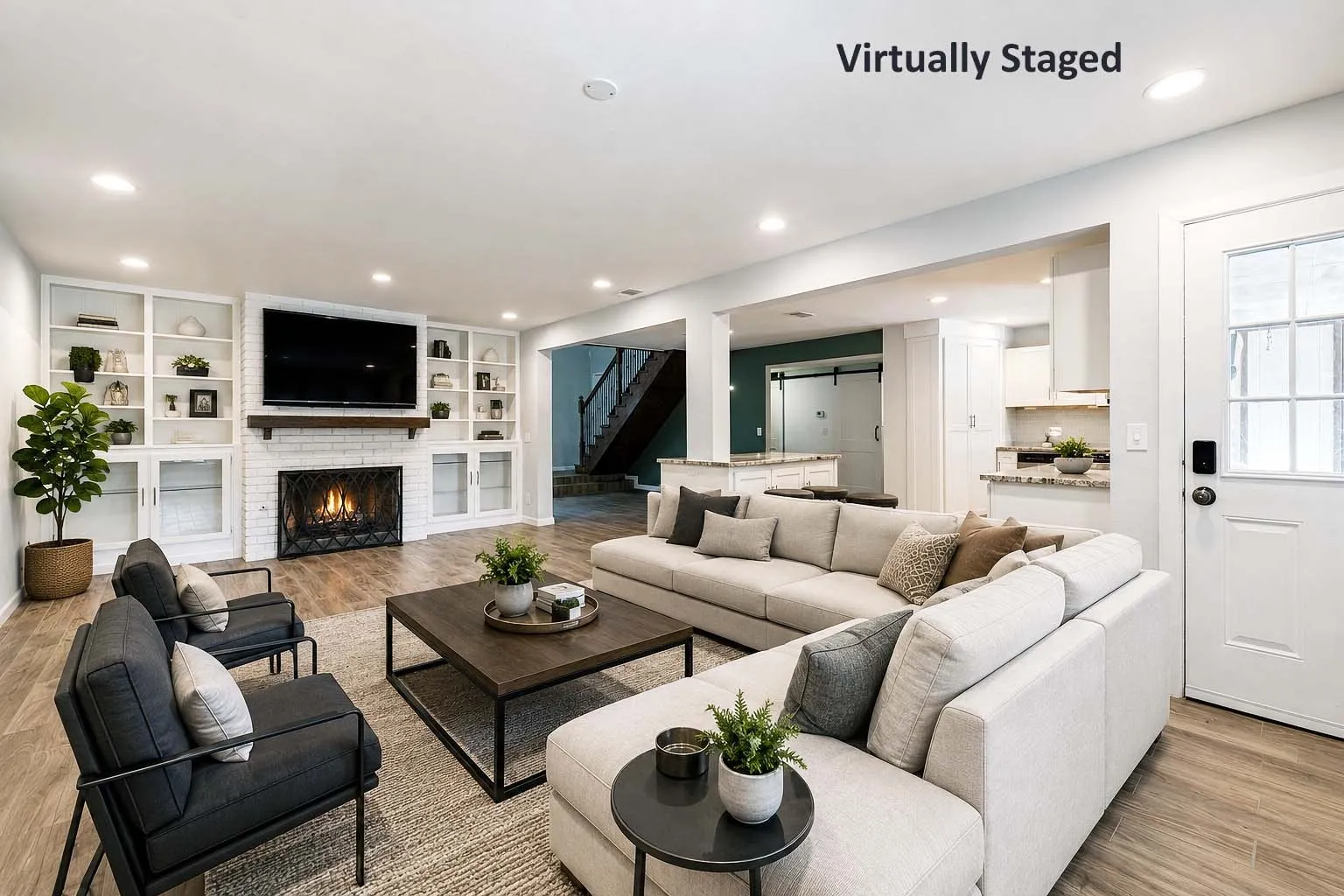 Living area featuring wood-finish flooring, a white brick fireplace with a dark wood mantle, and built-in shelving with glass-front cabinets