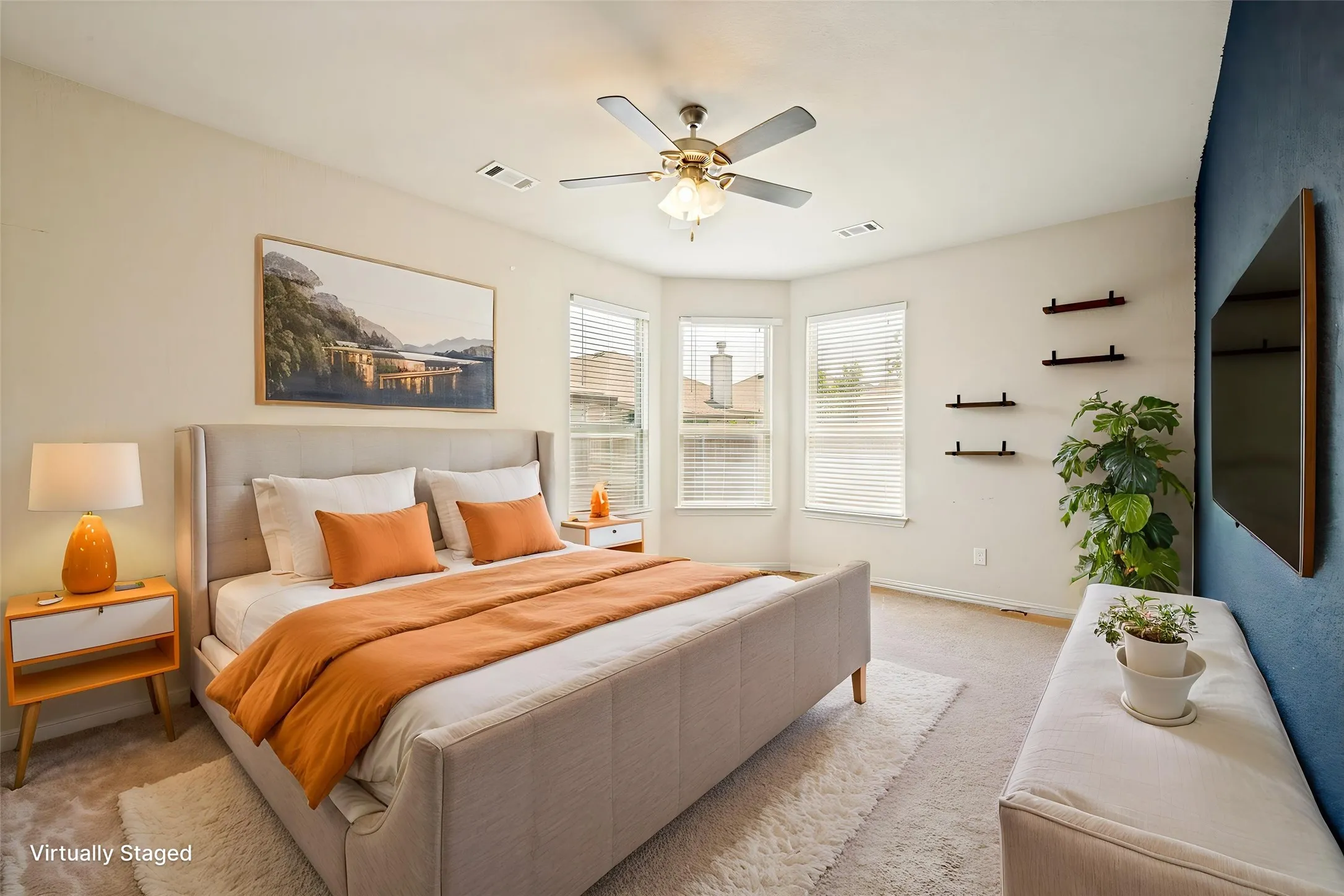 Carpeted bedroom featuring a ceiling fan, bay windows with blinds, and white wall paint