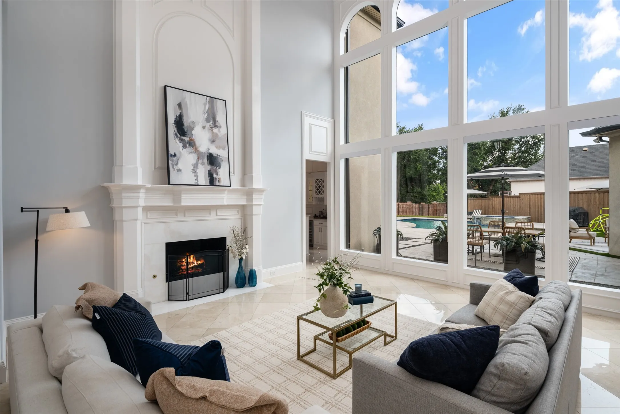 A stunning fireplace anchors the spacious family room while expansive windows frame beautiful backyard views. This impressive space combines architectural elegance with warmth and everyday comfort.