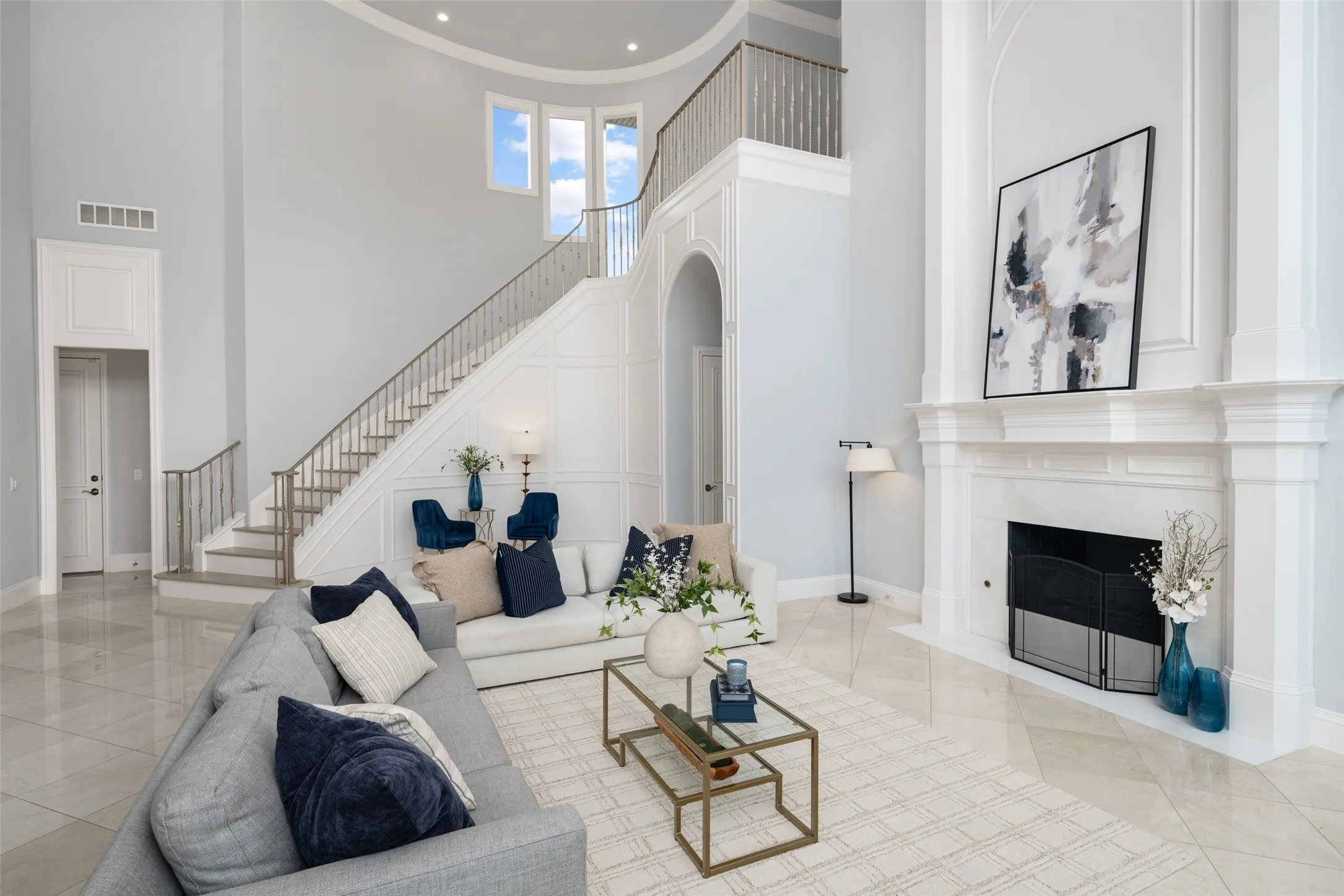 The sweeping staircase, extensive millwork, and soaring ceilings showcase exceptional craftsmanship while creating a seamless flow between the home's grand living spaces.