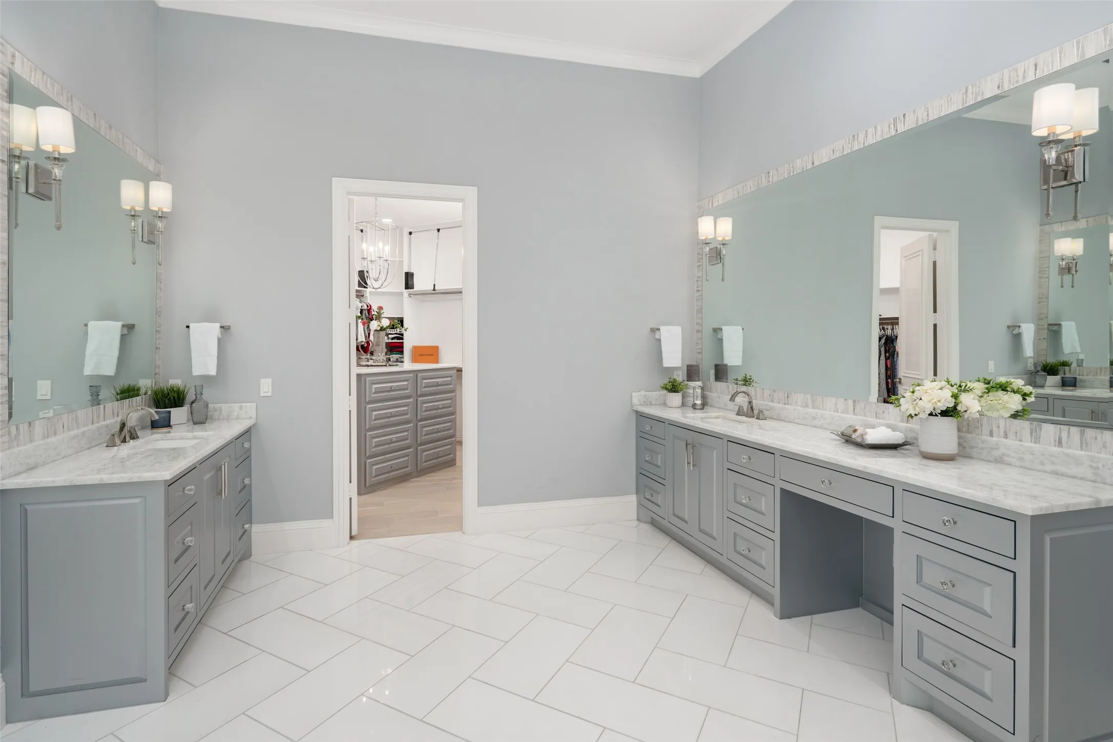 Separate dual vanity areas provide generous storage, expansive mirrors, marble countertops, and individual space, creating both convenience and privacy within the luxurious primary bath.