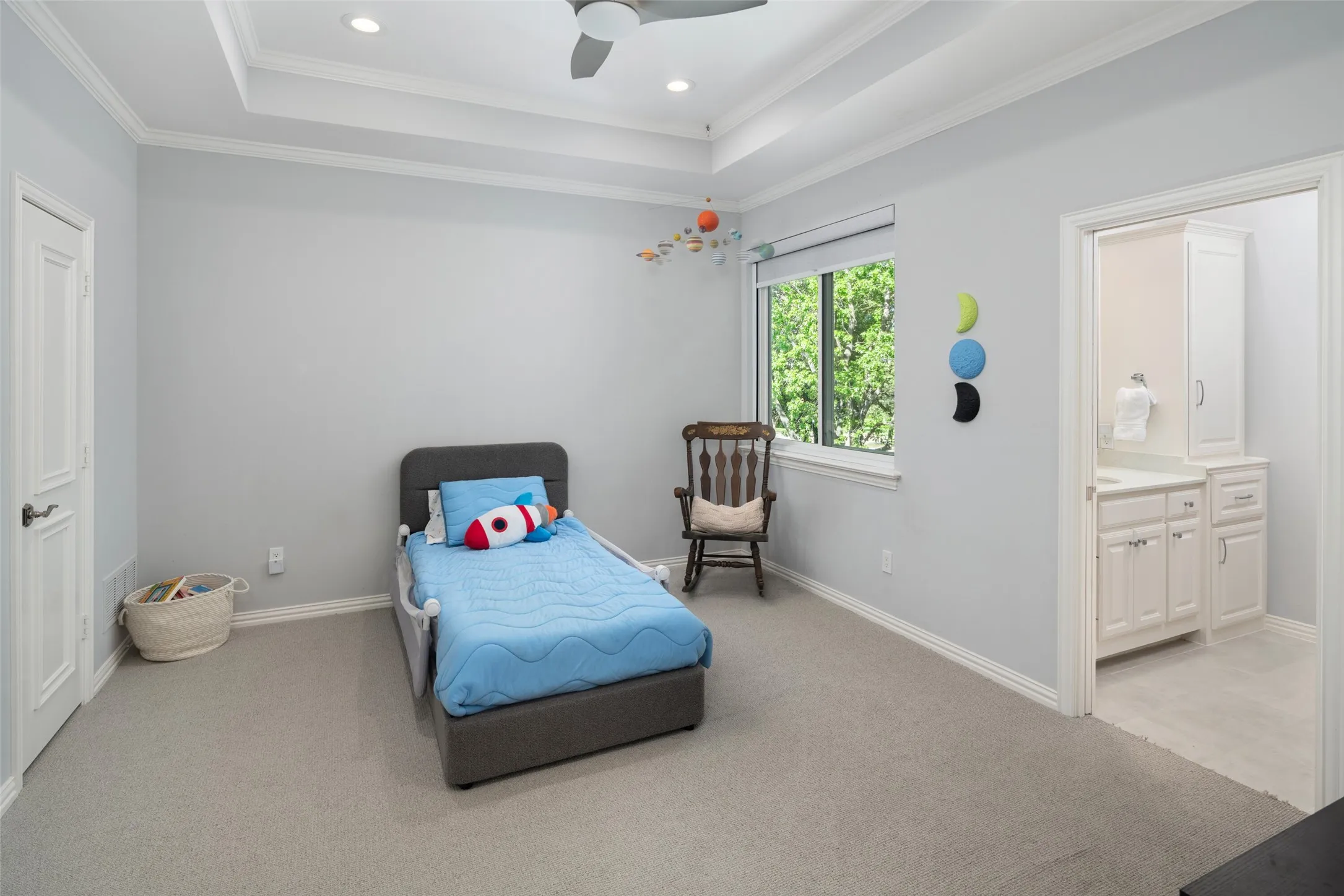 Bright secondary bedroom offers generous space, tray ceilings, and direct access to a jack and Jill bathroom