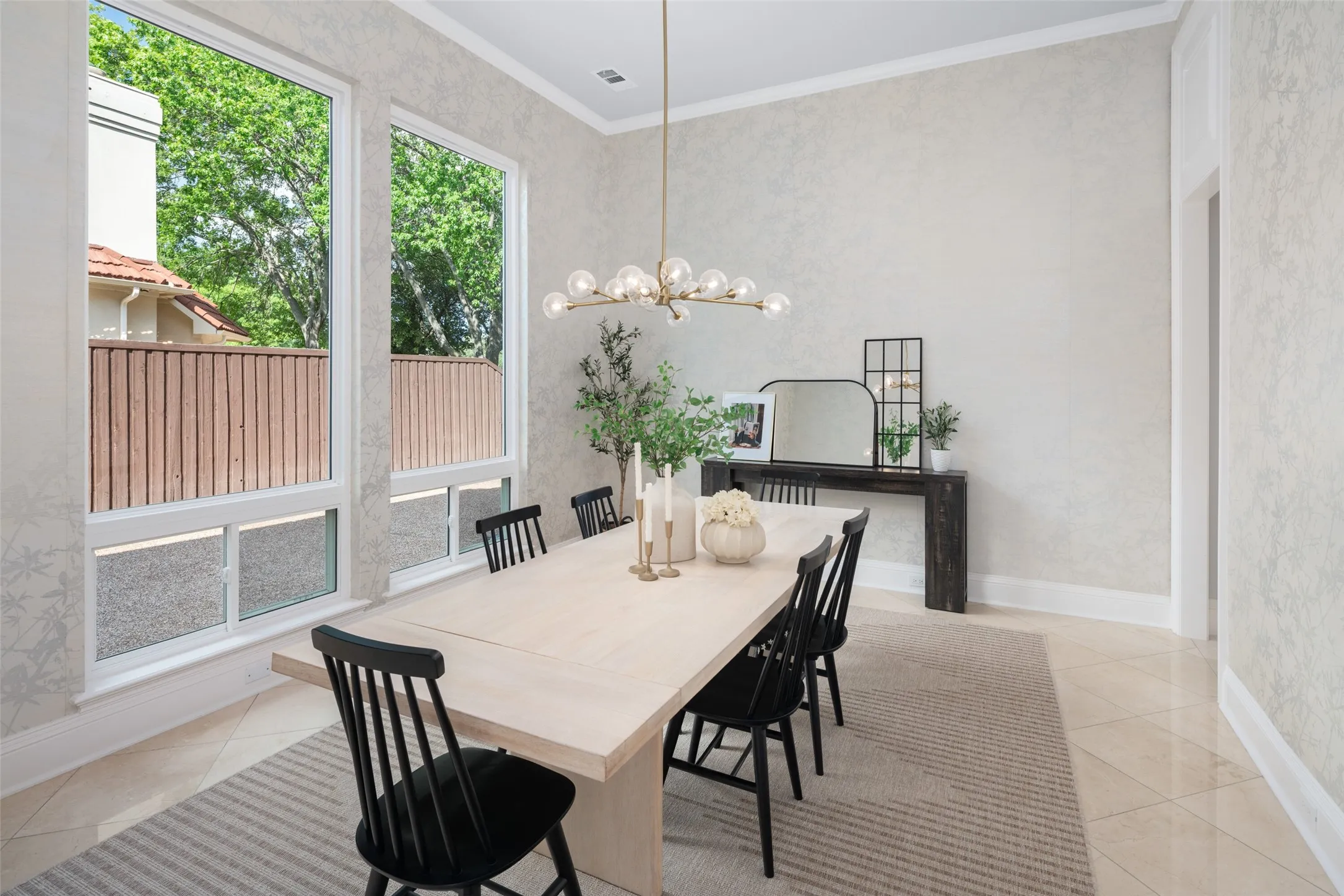 The formal dining room offers an elegant setting for holidays and celebrations, highlighted by designer lighting, refined wall treatments, and generous proportions that comfortably accommodate family and guests.