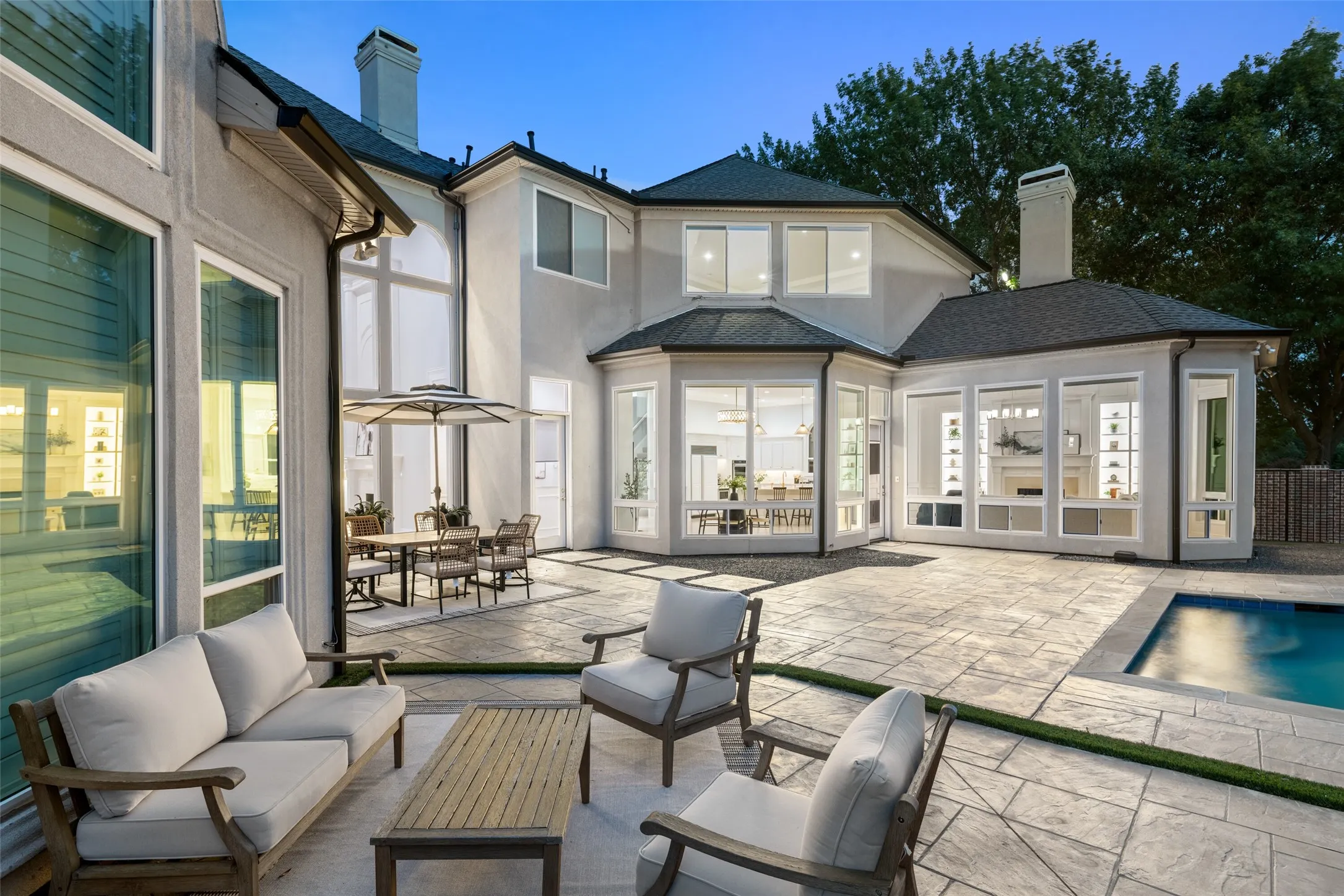Designed for effortless entertaining, the backyard blends expansive patios, sparkling pool, covered seating, and lush turf into a private outdoor retreat where every gathering feels like a vacation.