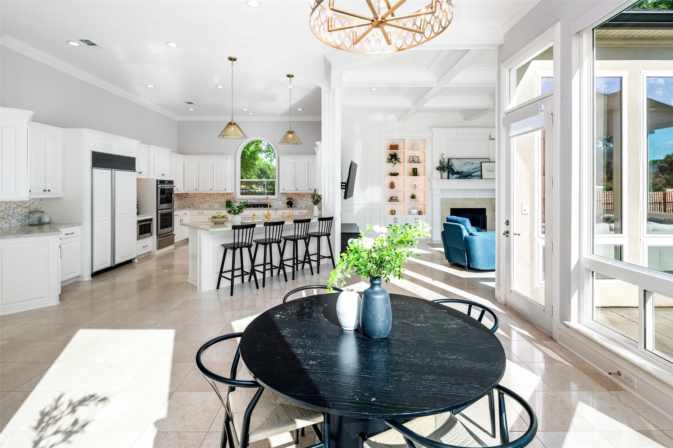 The breakfast area offers casual dining with pool views and flows seamlessly into the gourmet kitchen and spacious family room, creating an ideal setting for everyday living and entertaining.