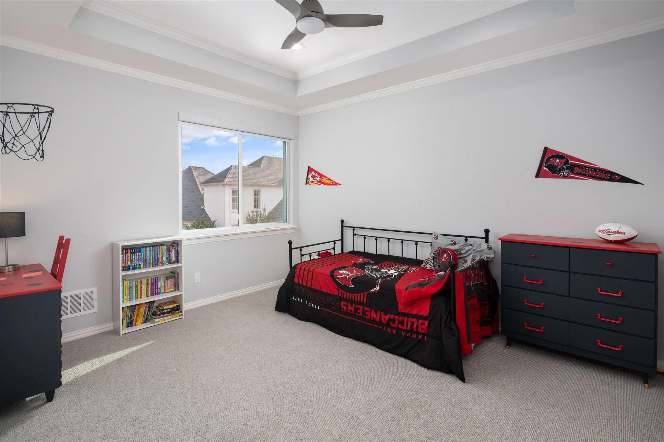 Spacious secondary bedroom includes tray ceilings, large picture window, neutral finishes, and ample room for furnishings, providing a comfortable private retreat for family or guests.