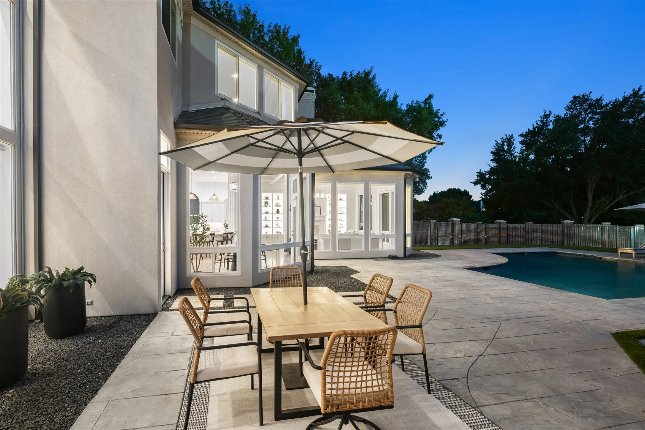 Whether hosting dinner with friends or enjoying a quiet morning coffee, this inviting outdoor dining space overlooks the pool and offers seamless access to the home's open living areas.