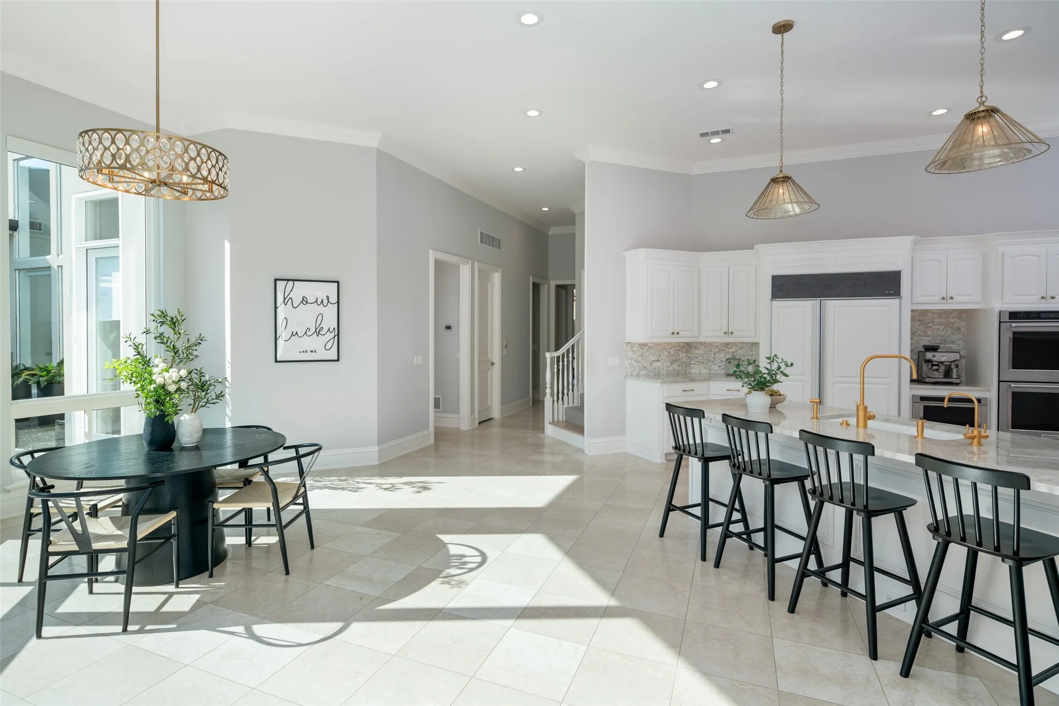 Enjoy morning coffee surrounded by natural light in the breakfast room, perfectly positioned beside floor-to-ceiling windows with peaceful views of the pool, patio, and beautifully landscaped backyard.
